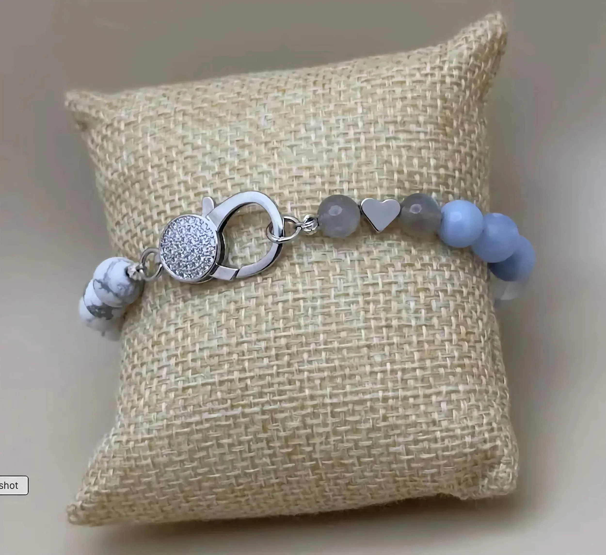 an elegant "coastal formal" anchor bracelet combining the calming energy of howlite with a high-glamour sterling silver clasp.