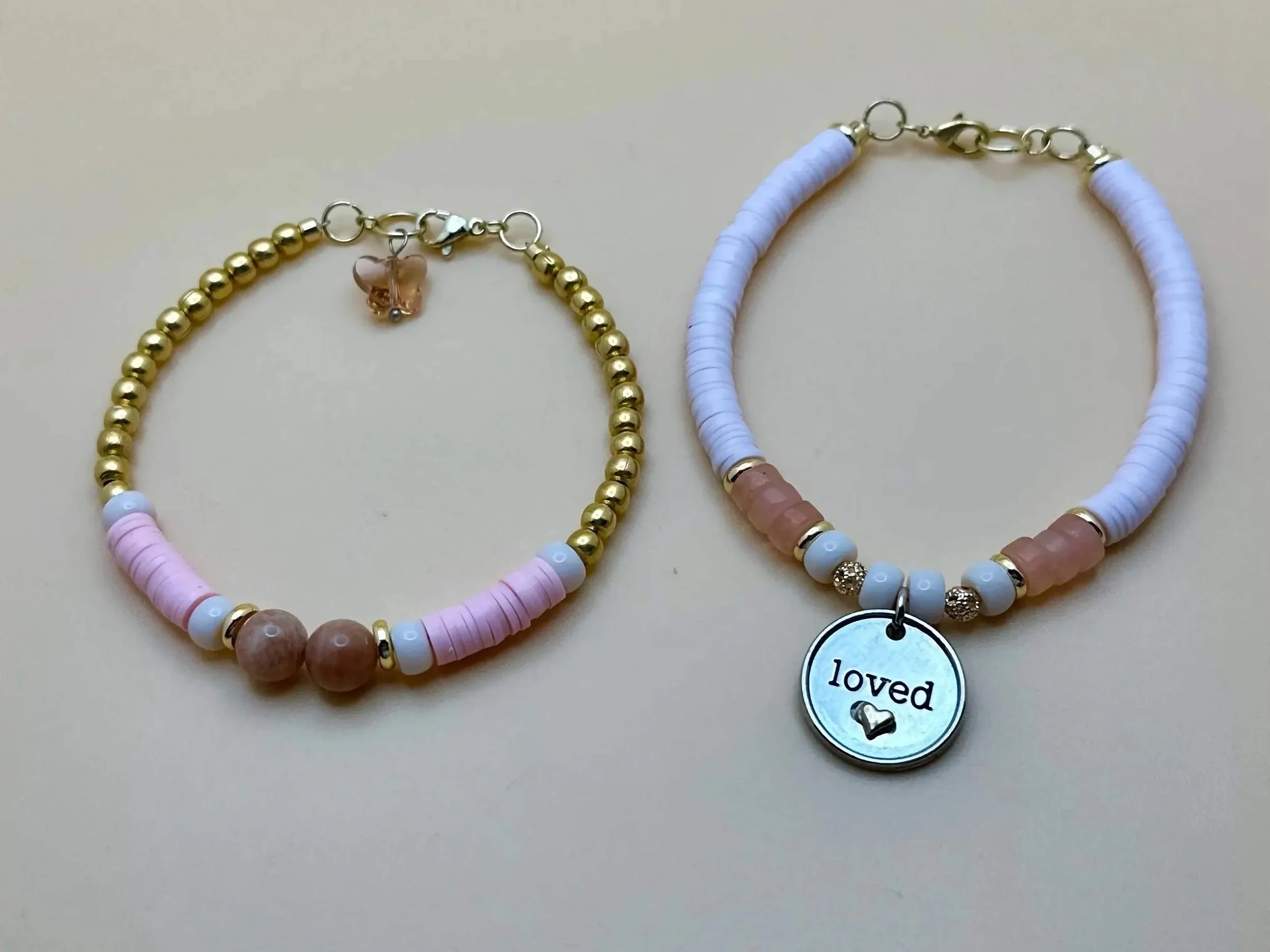 a soft, romantic jewelry stack displaying the natural variations in rose quartz and sunstone beads.