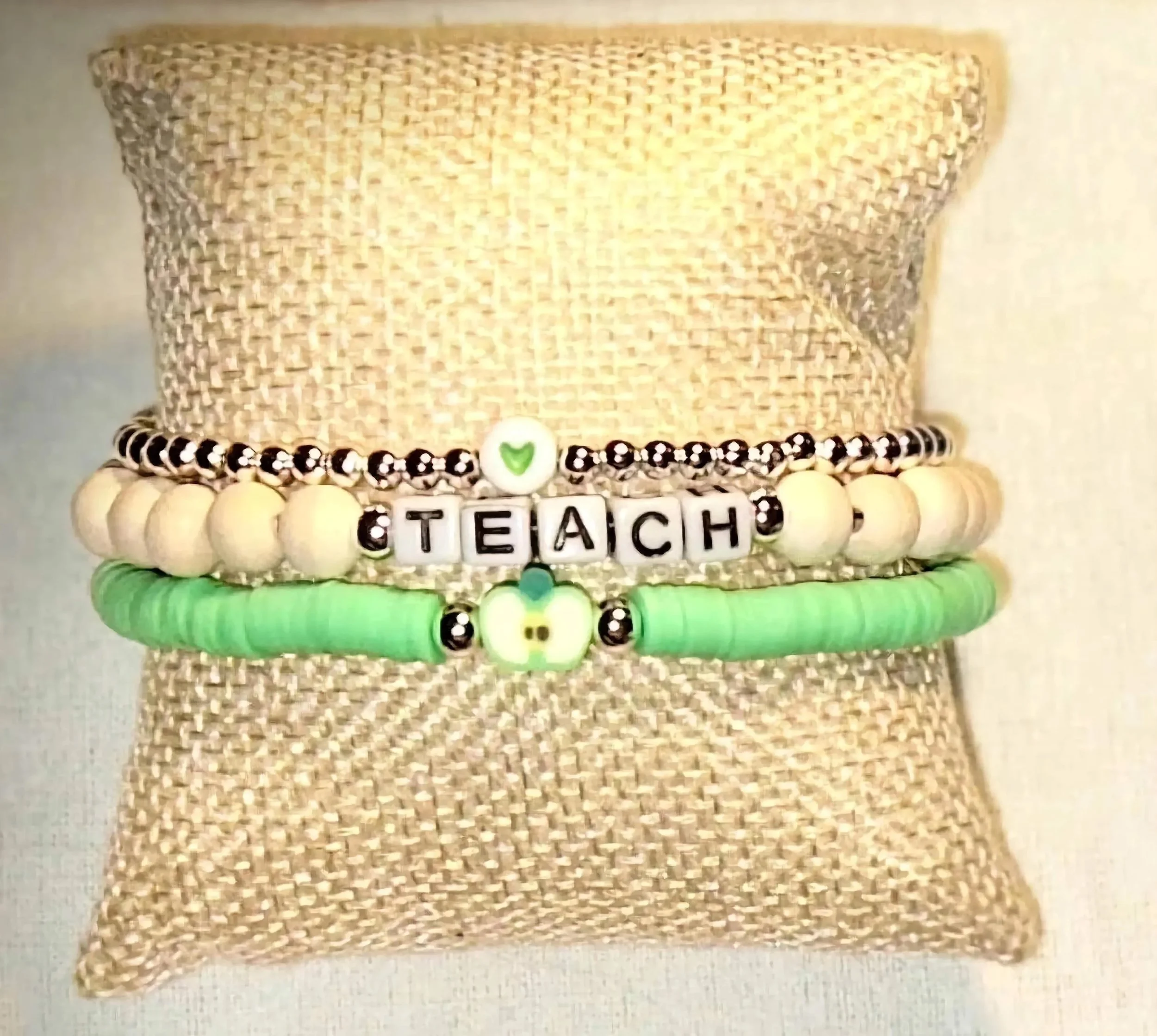 minimalist mentor jewelry set featuring a 3mm sterling silver dainty bracelet stack with a green apple charm.