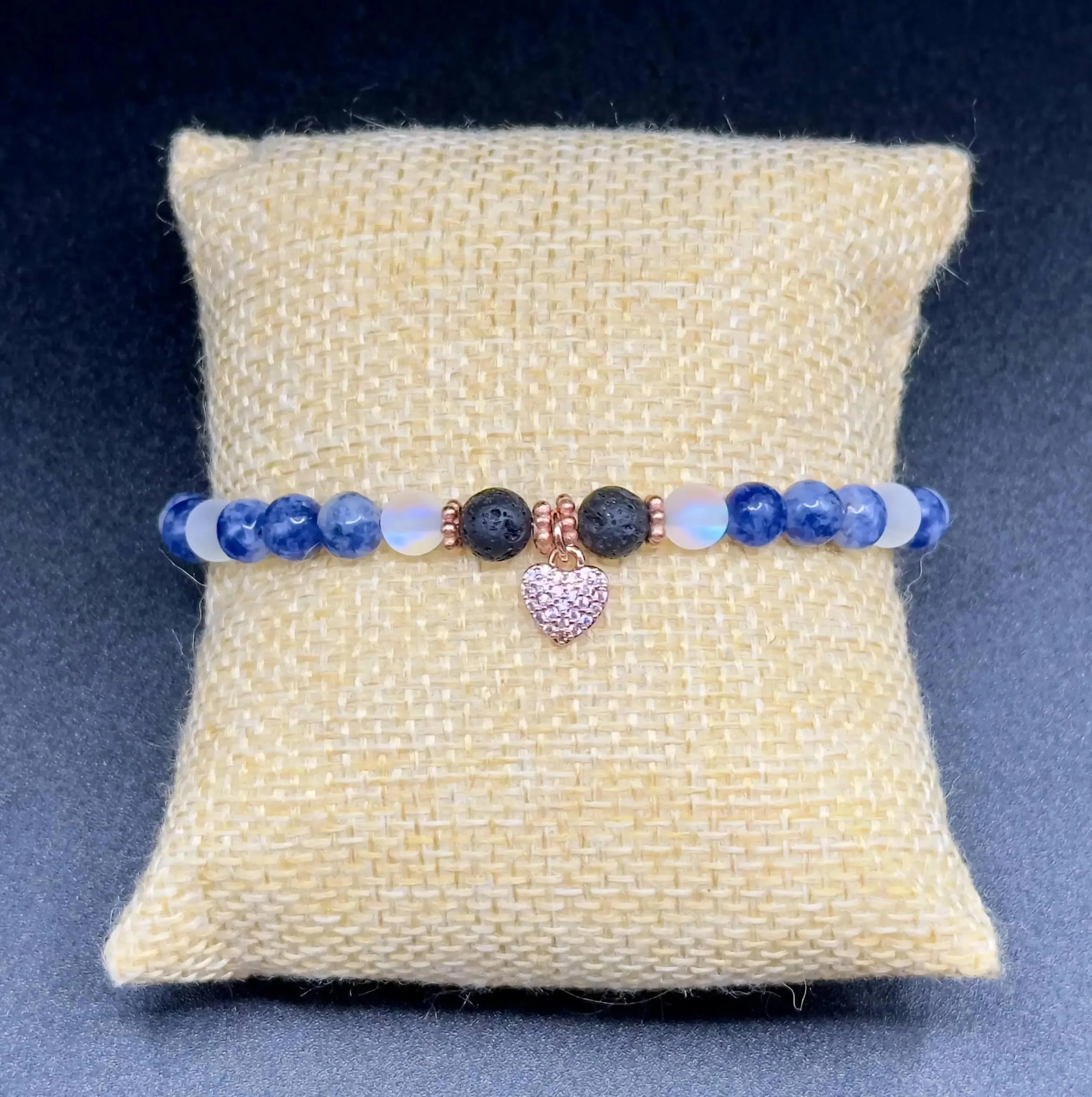 a sophisticated take on the charm bracelet with a focal cluster of blue gemstones and durable gold-filled accents.