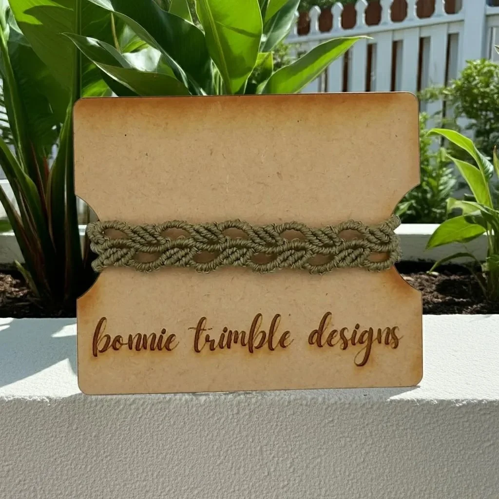 a master-level macramé stacking bracelet featuring a repeating botanical-inspired pattern and signature wood tail beads.