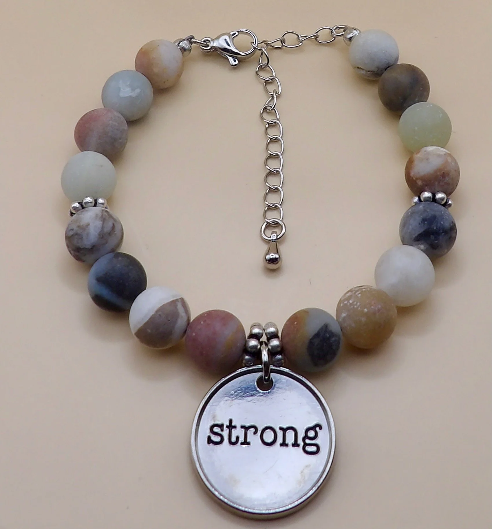 handmade matte amazonite gemstone bracelet with silver inspirational word charm and stainless steel daisy spacer beads.