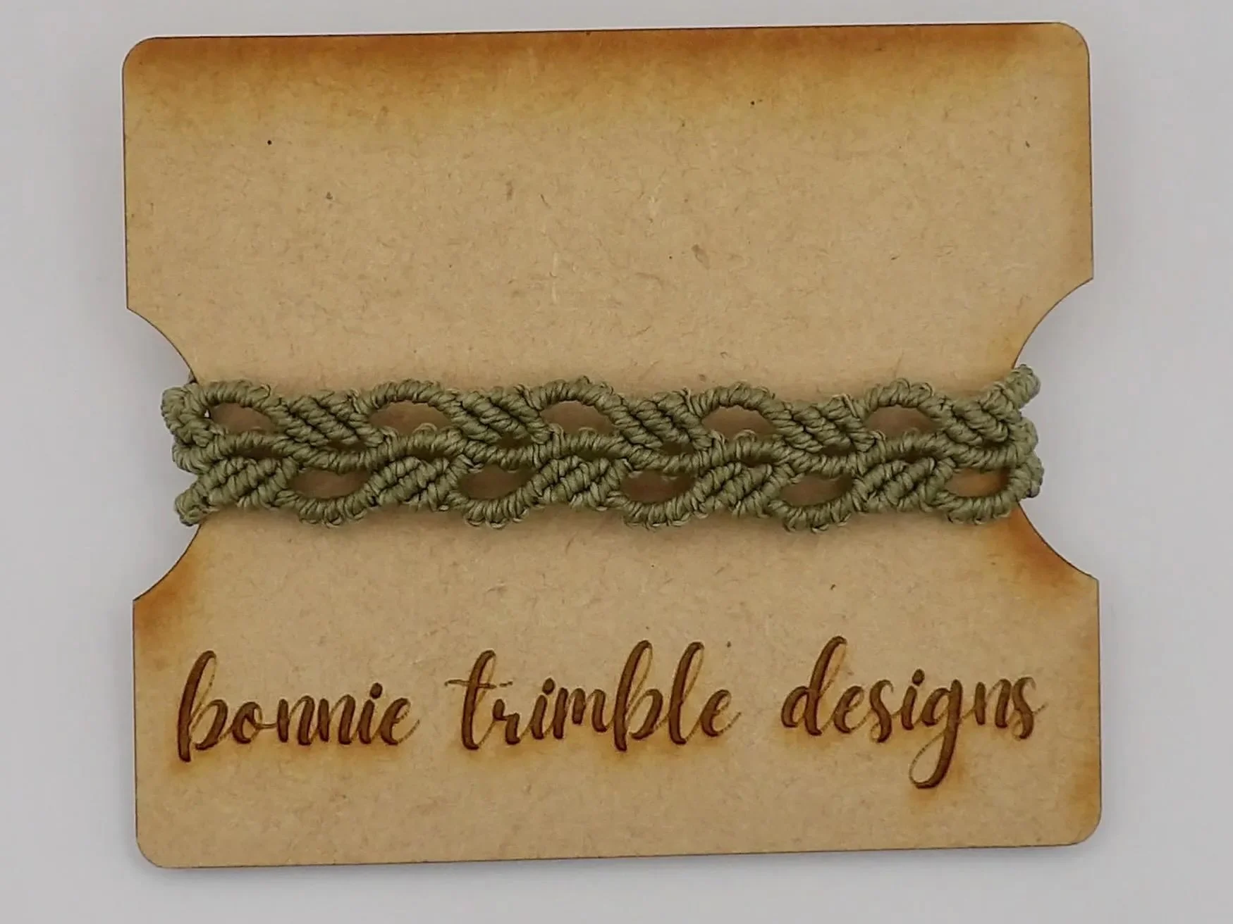 a dainty yet resilient fiber bracelet featuring a signature botanical knot pattern and adjustable fit for all wrist sizes.