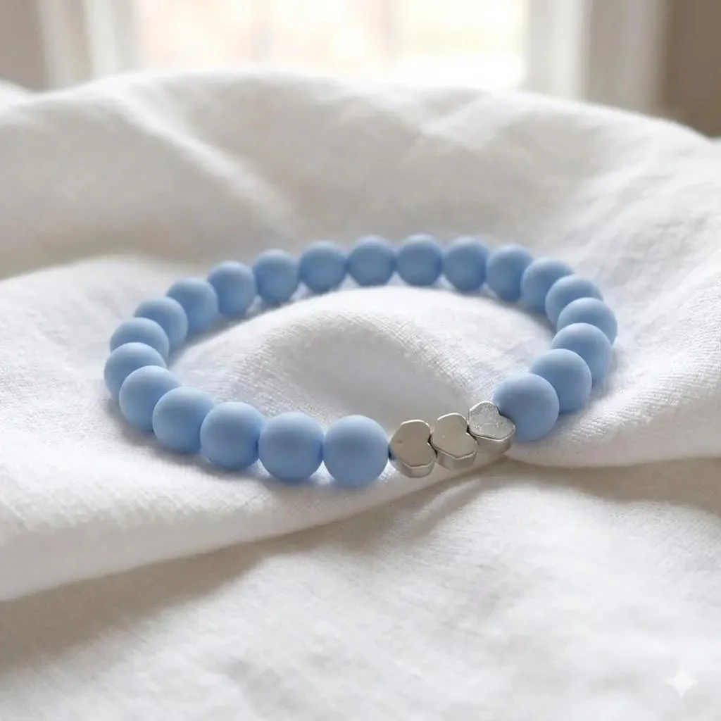 handcrafted "playful dreamer" jewelry featuring a repeating heart pattern and tarnish-resistant metallic hardware.