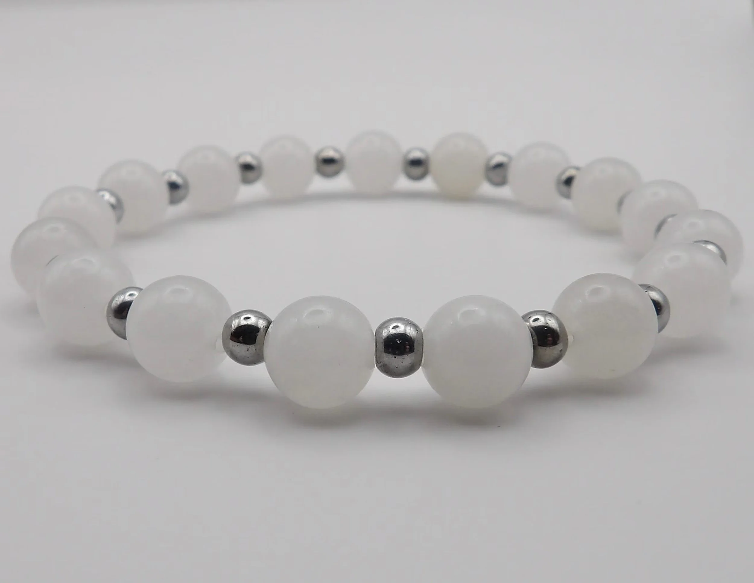 detailed view of the natural inclusions in the peach moonstone and the frosted glow of the rose quartz beads.