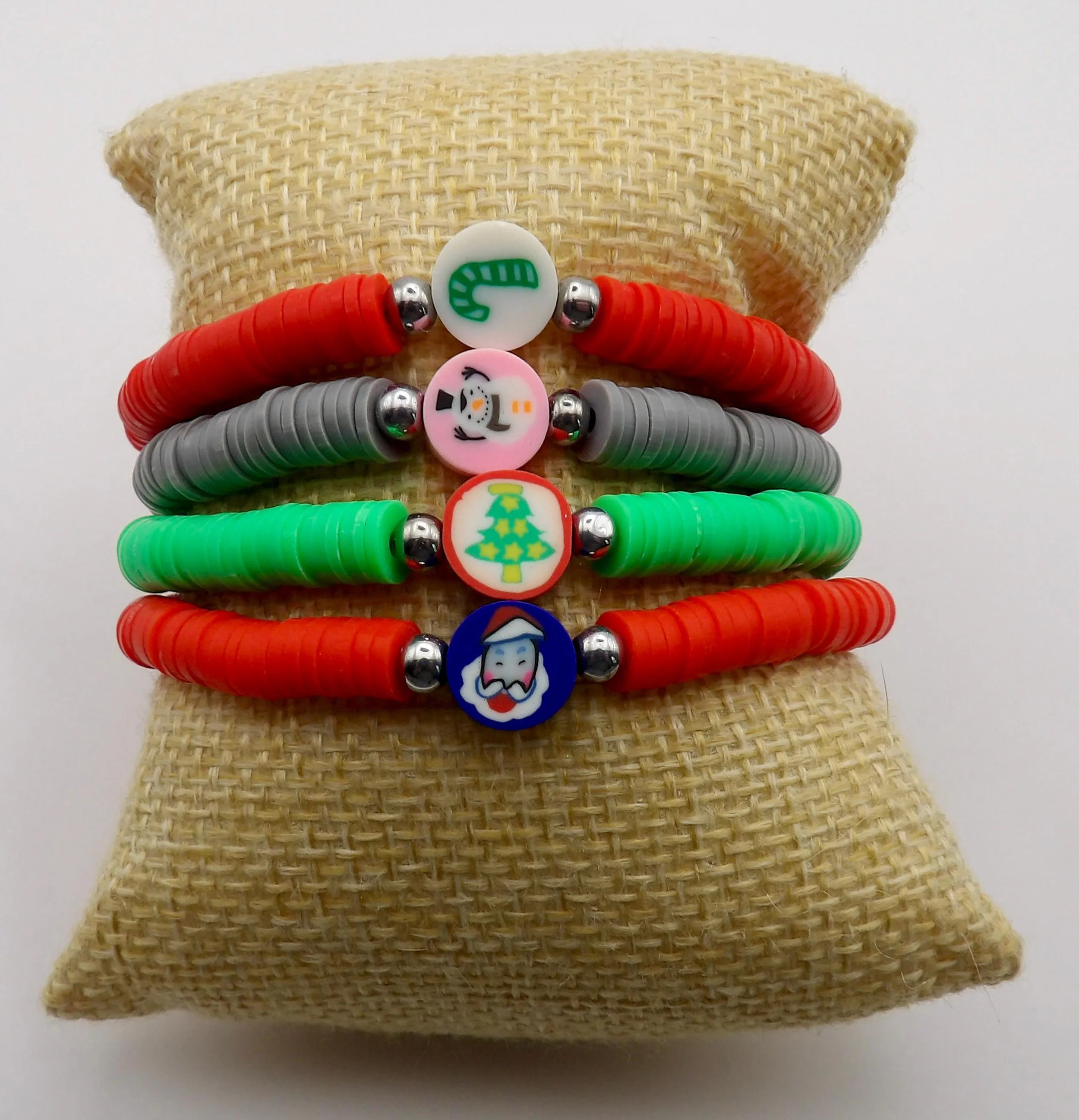 close-up of the holiday enthusiast bracelet showcasing the detailed christmas focal bead and layered colorful heishi spacers.