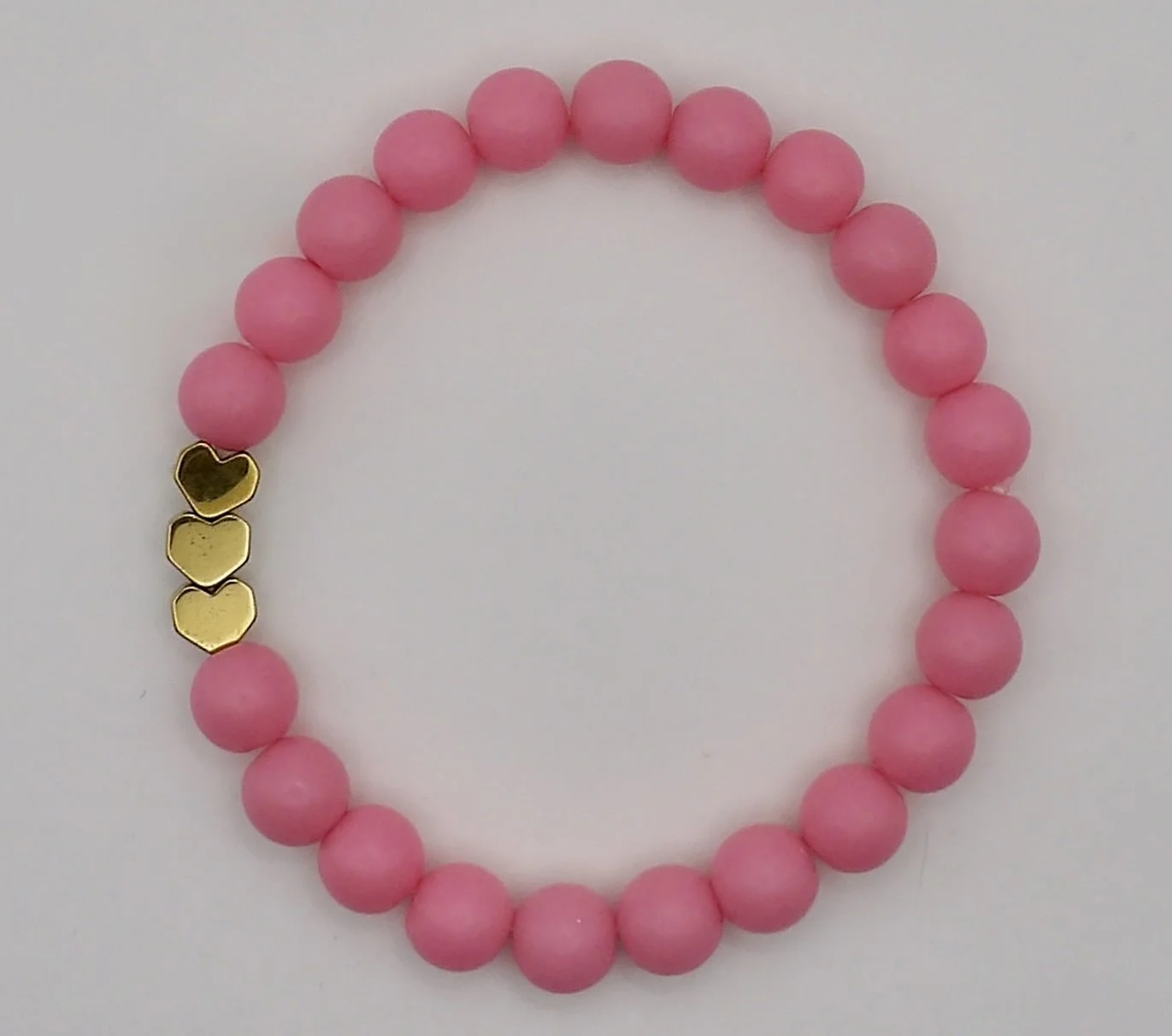 sweet dreams matte heart bracelet in hot pink color with a shiny gold heart accent bead.