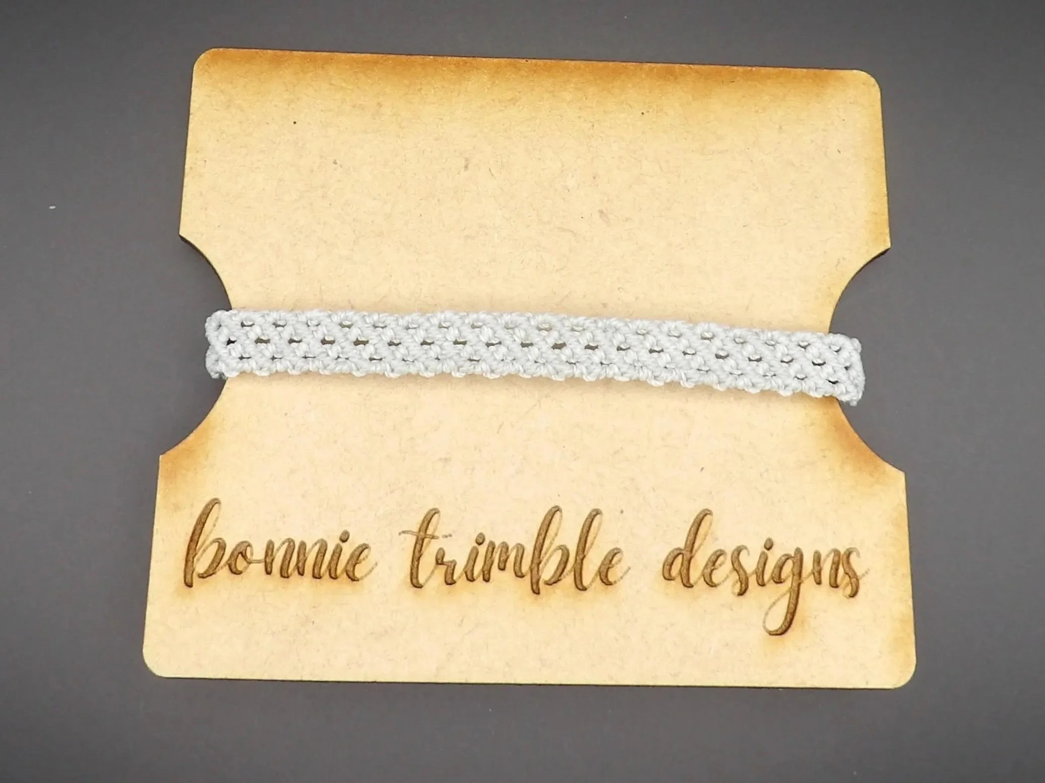 a master-level micro-macramé piece featuring a rhythmic gray weave that mimics the look of high-end industrial textile.