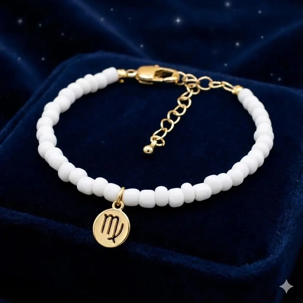 adjustable celestial dreamer jewelry showing the high-shine gold zodiac symbol and delicate white beadwork.