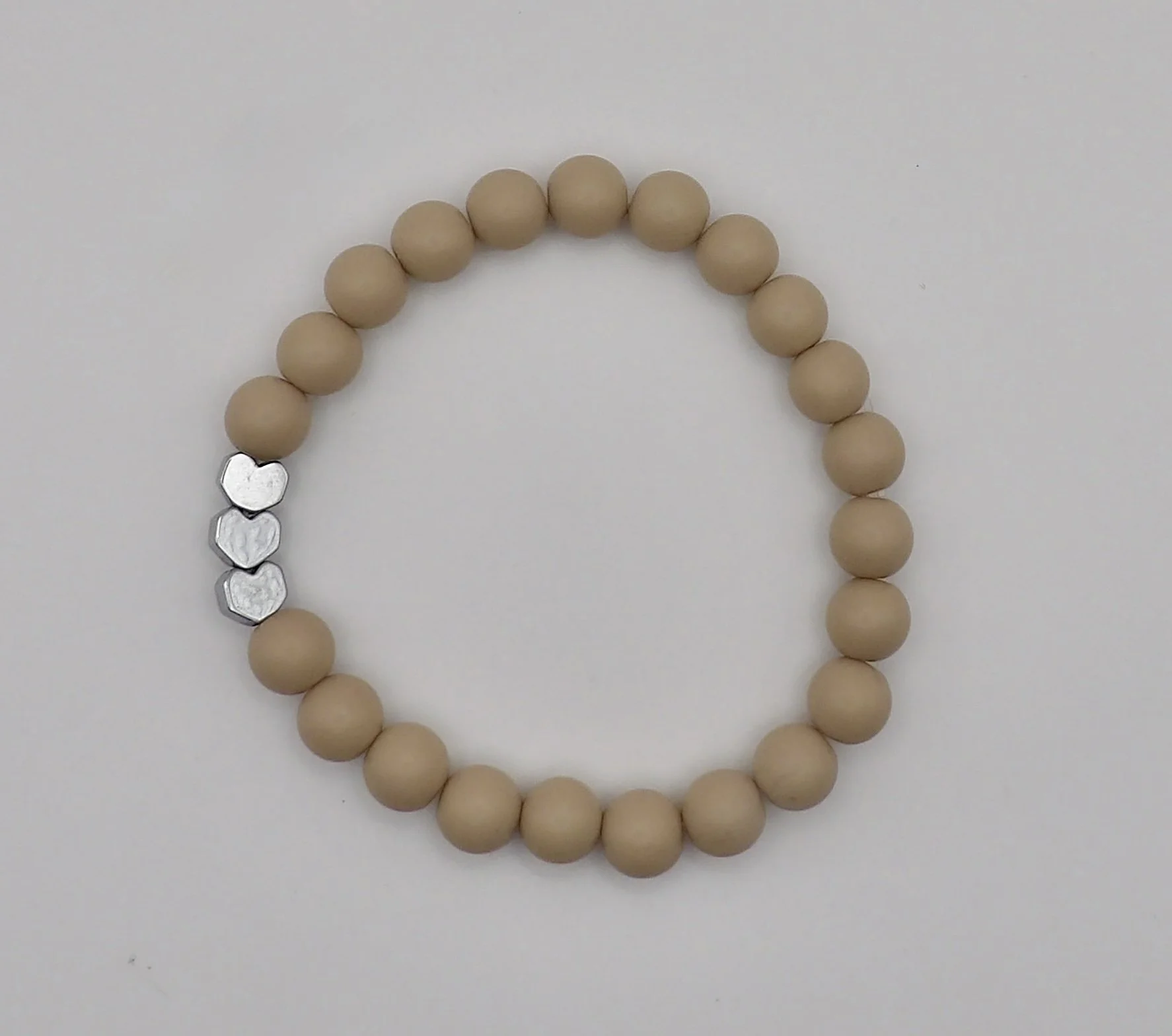 sweet dreams matte heart bracelet in soft chocolate color with a shiny silver heart accent bead.