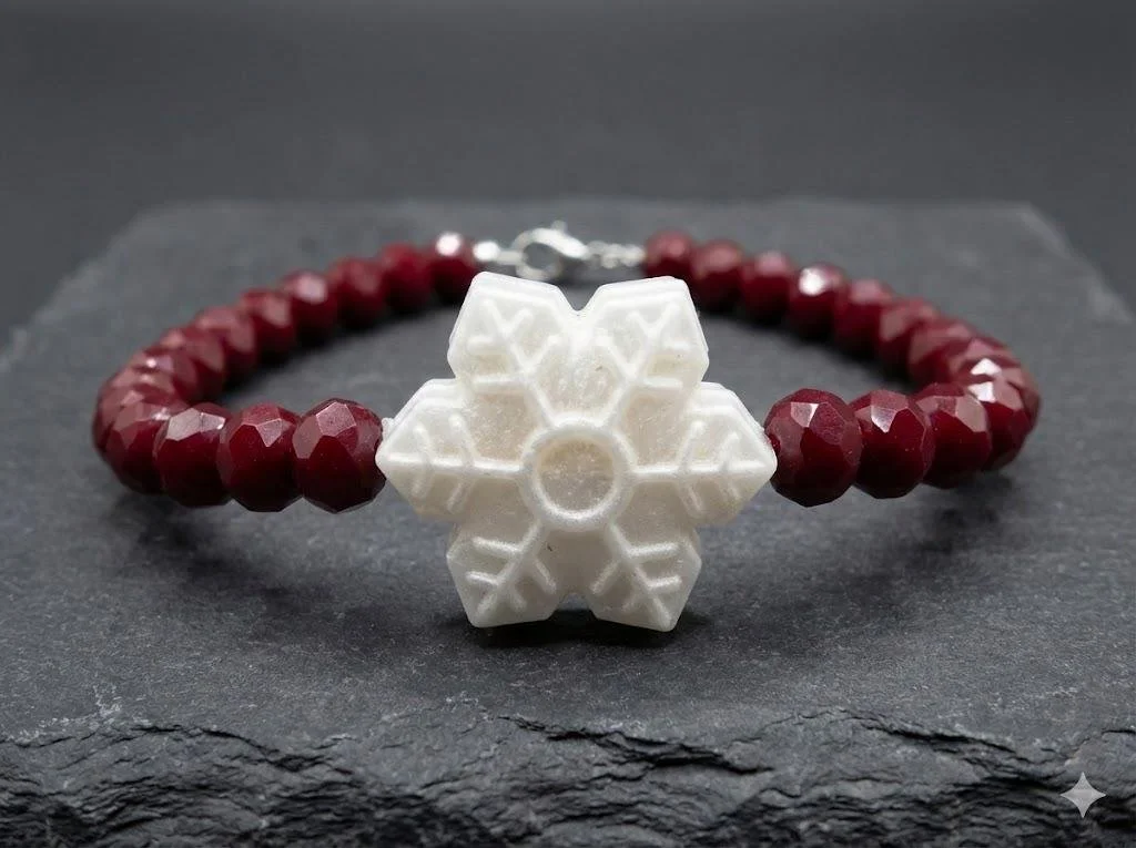 close-up of the winter sparkle bracelet highlighting the icy shimmer of the glass and the matte texture of the snowflake.