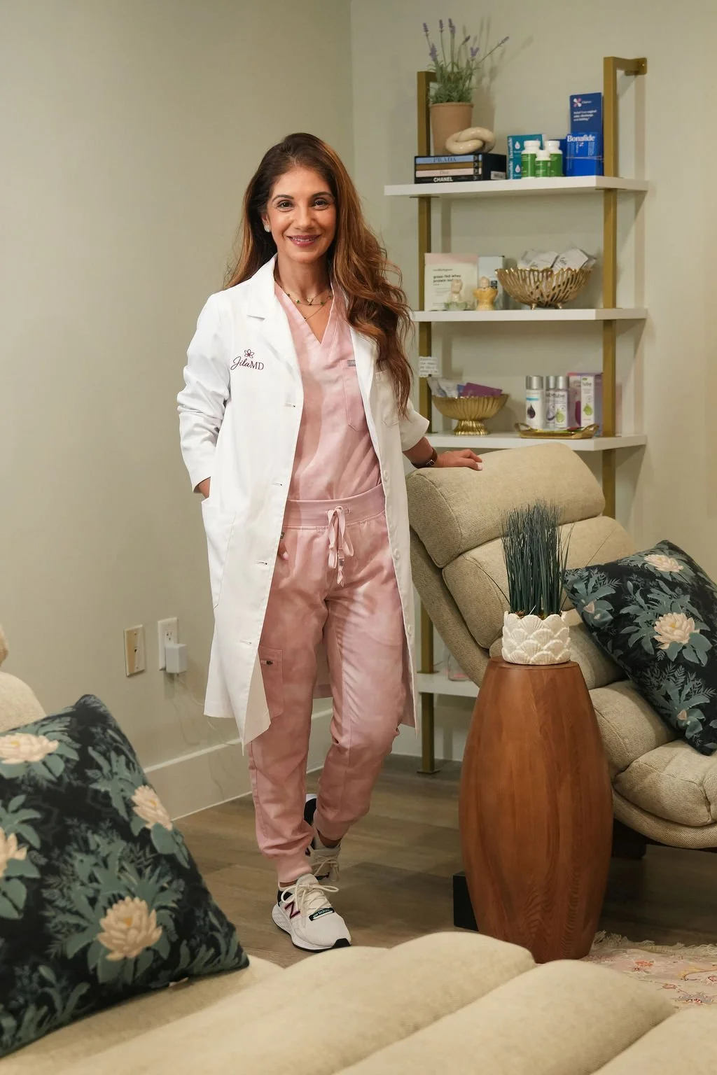 Dr. Jila in medical coat standing in her office