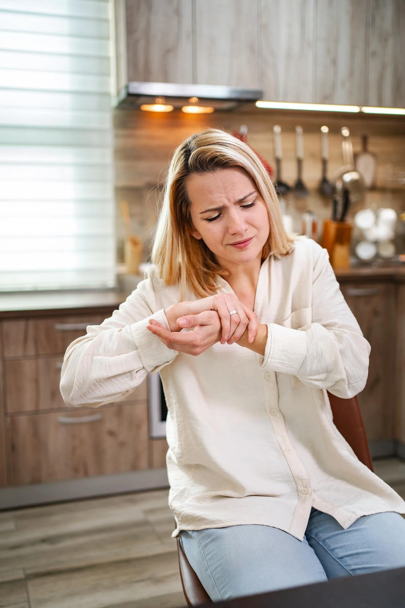 Woman experiencing aching finger joints during menopause.