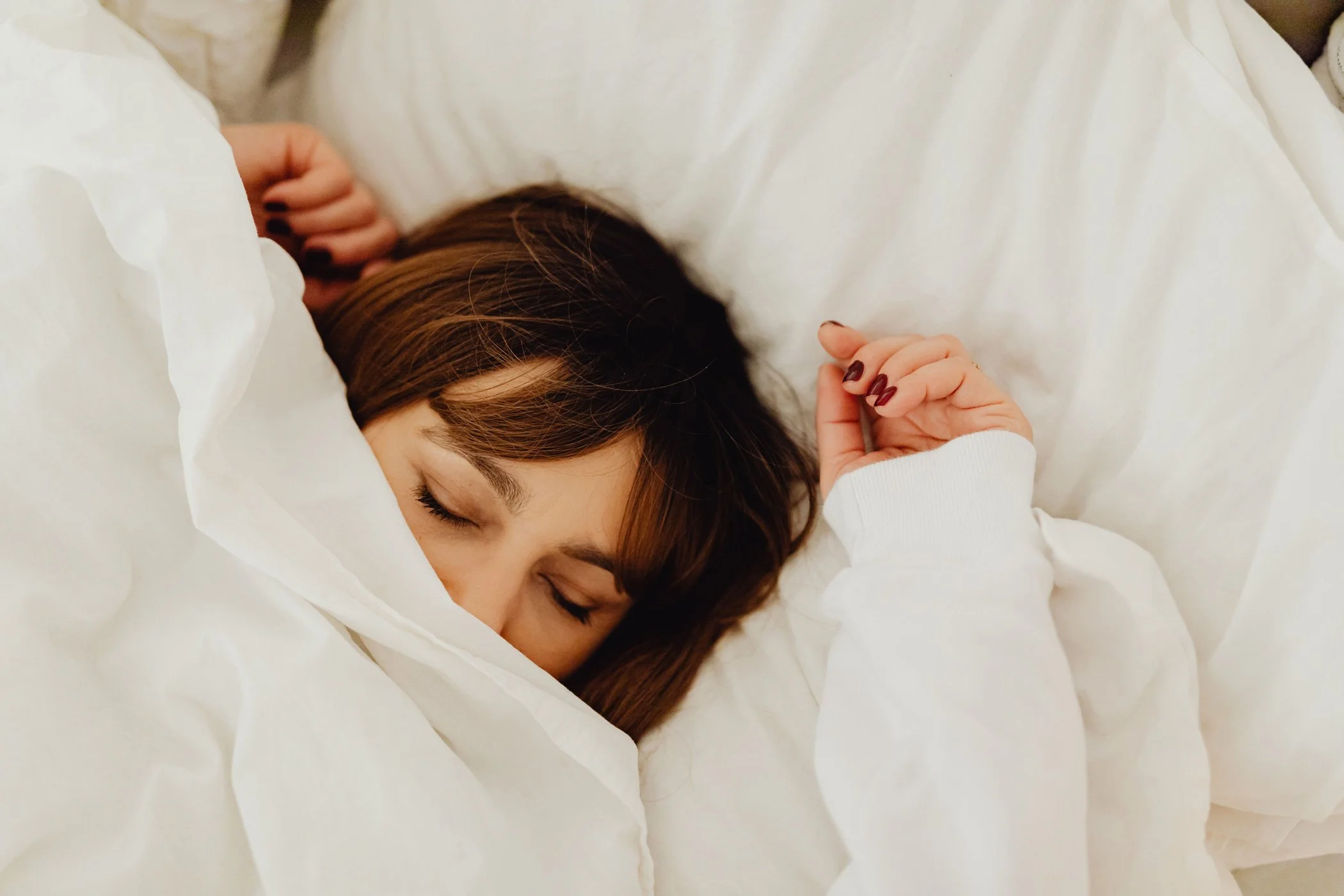 Woman awake at night with menopause-related sleep disruption that can worsen brain fog