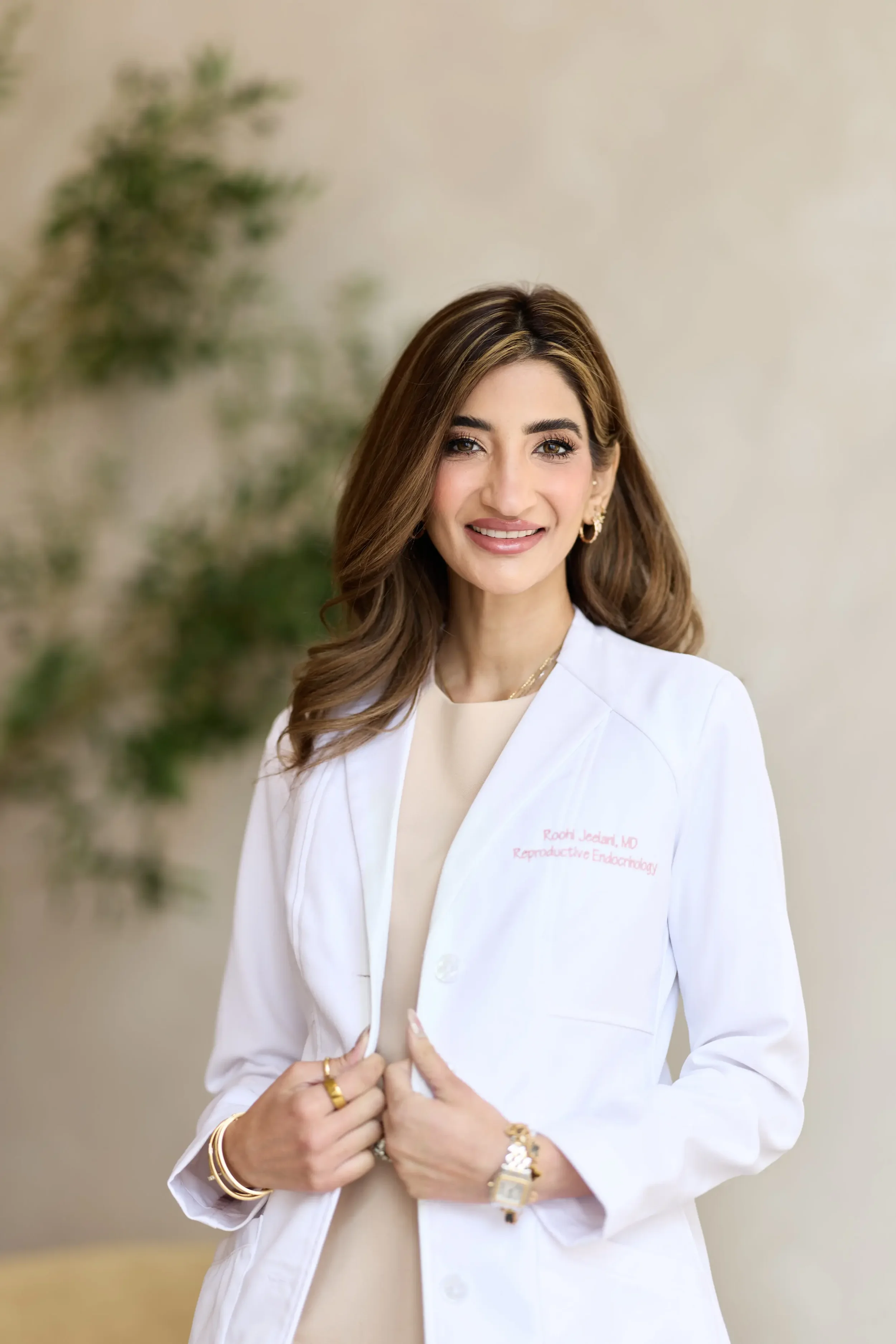 Dr. Roohi Jeelani wearing a white physician's coat