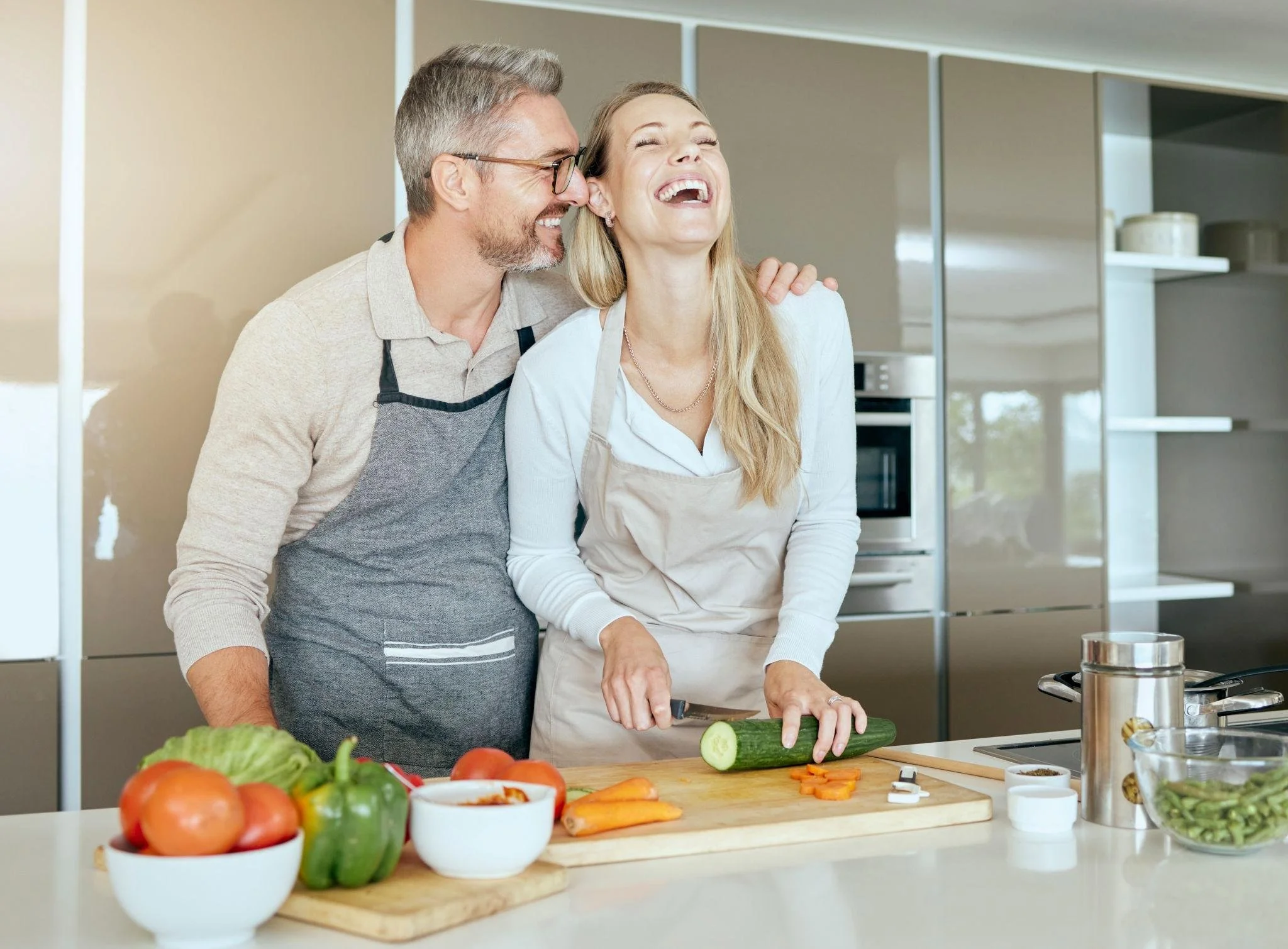 Woman in her late 30's talking about fertility with her partner while cooking in the kitchen