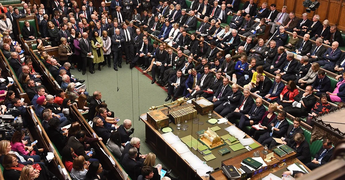 Members of the UK Parliament gathered in the House of Commons chamber during a session.
