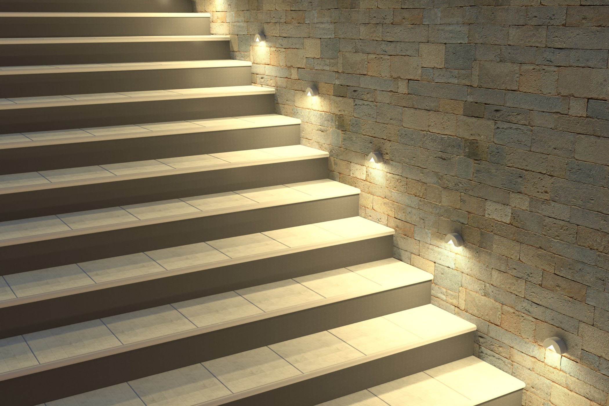 Modern tiled staircase beside a textured brick wall with illuminated step lights
