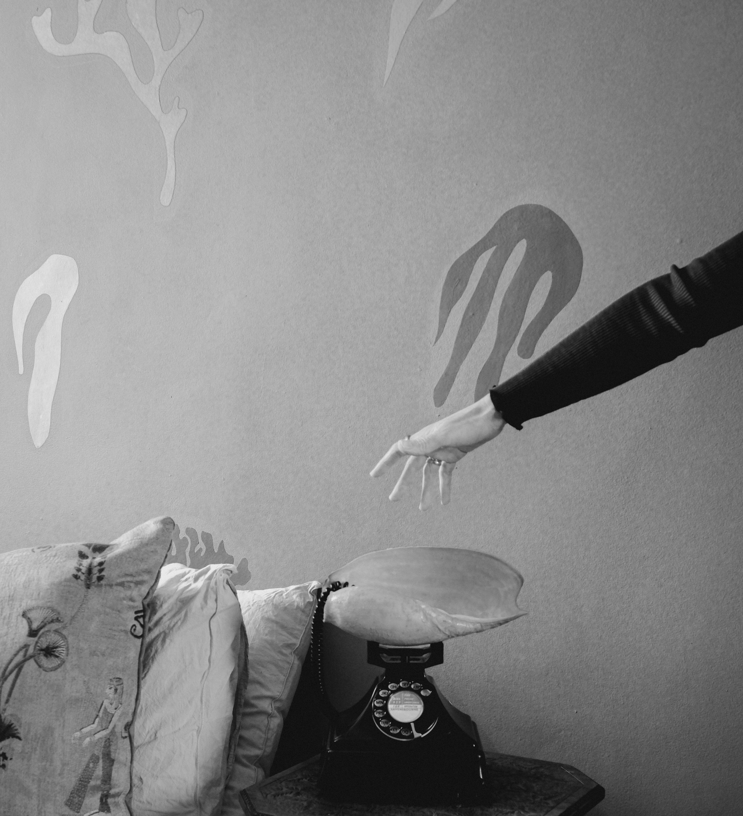 A vintage black rotary shell phone placed. Contact us.