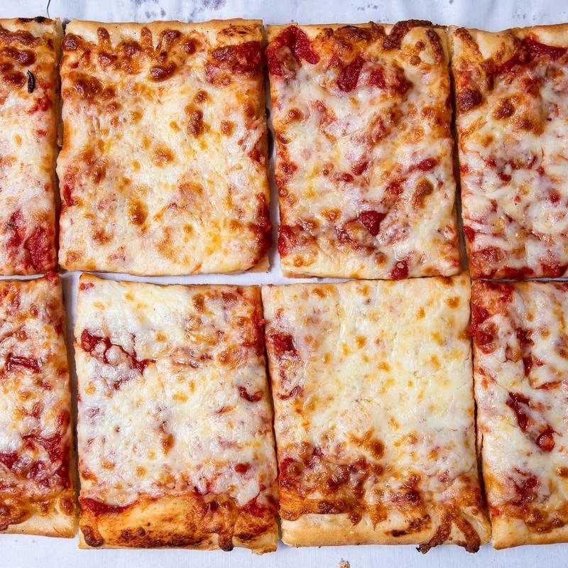 A close-up of eight rectangular slices of cheese pizza with a golden crust and melted cheese on top.