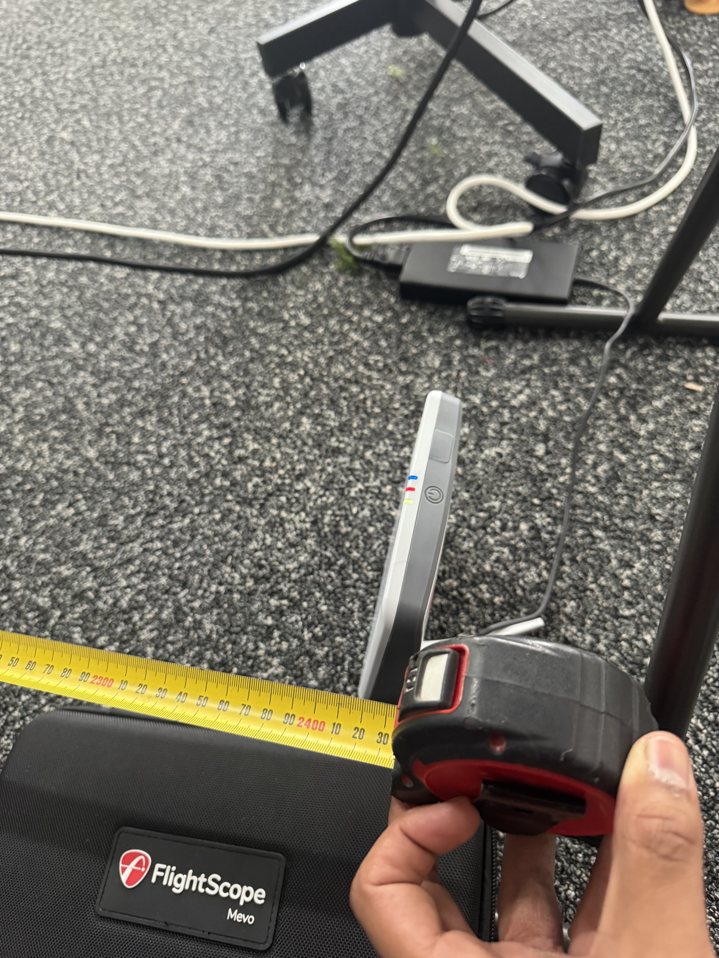 Tape measuring showing about 2.4 metres from the golf ball position to the impact screen .