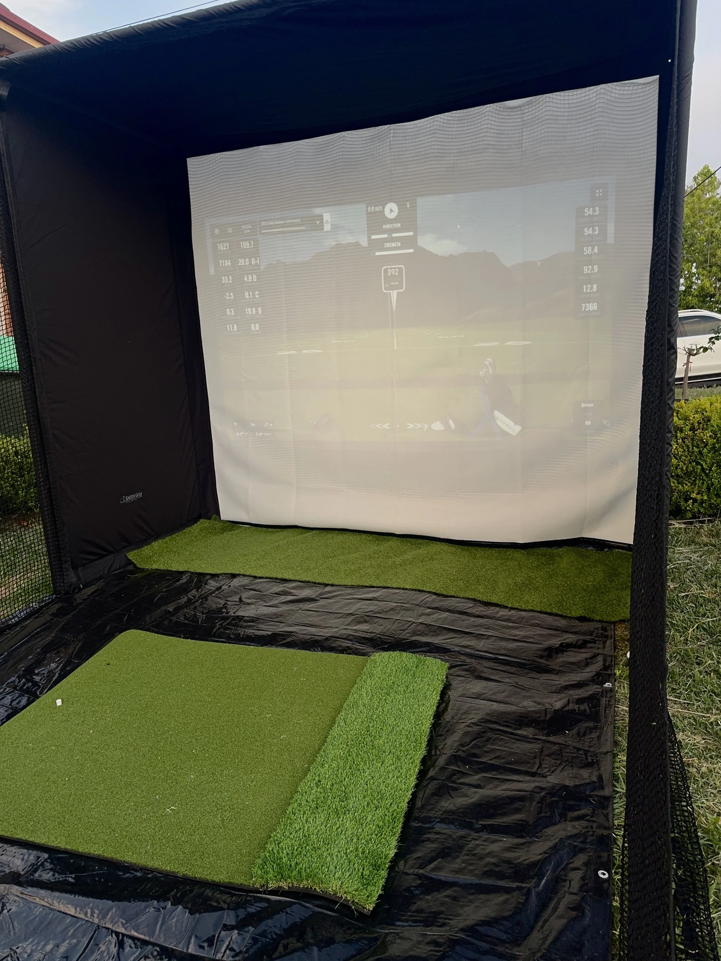 Practicing on the driving range by using a mobile golf simulator setup