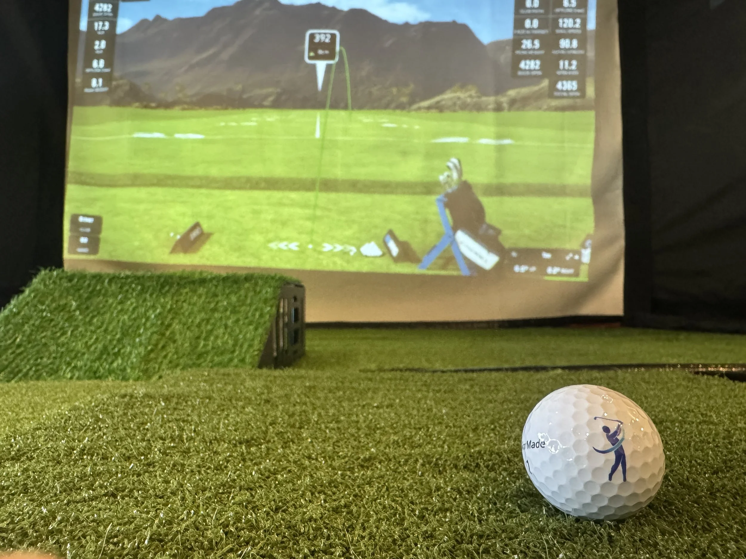 The Pop Up Golf ball sitting in a golf simulator