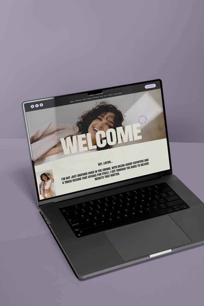 Open laptop displaying a website with a woman and the word "WELCOME" on the screen, set against a light purple background.