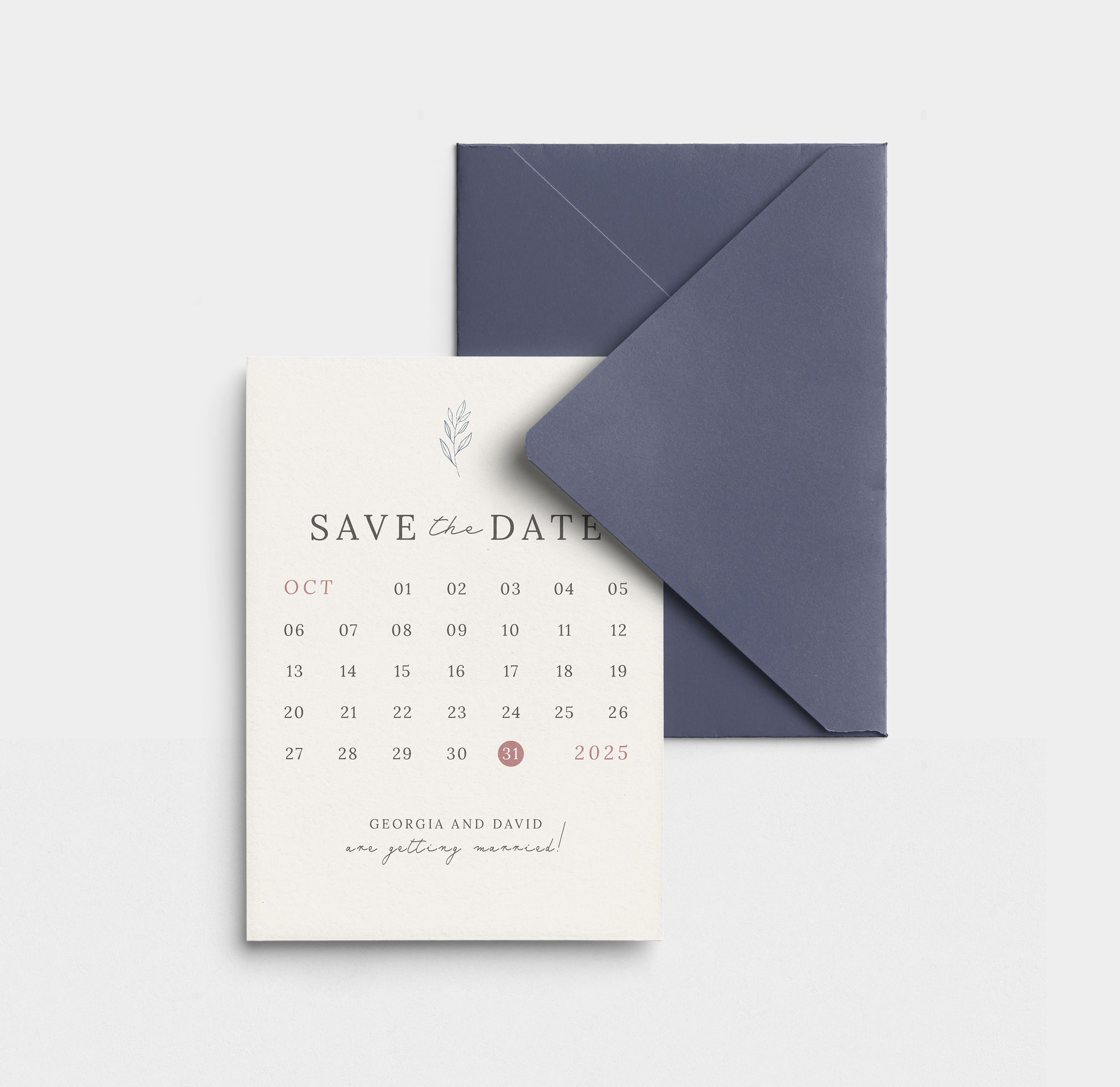 A 'Save the Date' wedding invitation with a calendar for October 2025, showing the 31st as the wedding date. The invitation has elegant black and pink text, a simple leaf illustration, and is accompanied by a matching navy blue envelope.