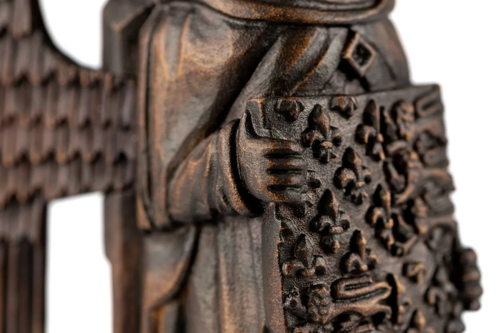 Close-up of a carved wooden sculpture featuring detailed floral and geometric patterns.