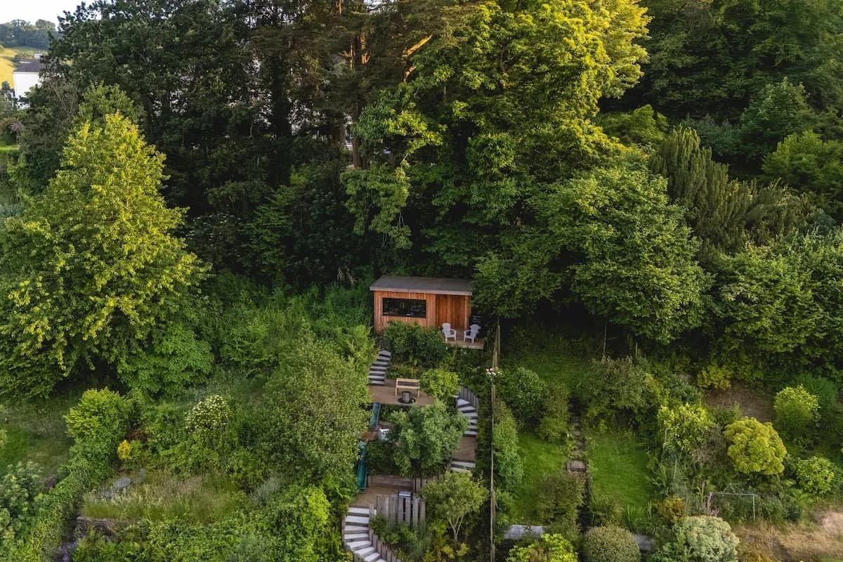 A shot of a cabin in an allotment taken from a drone in the air in Devon