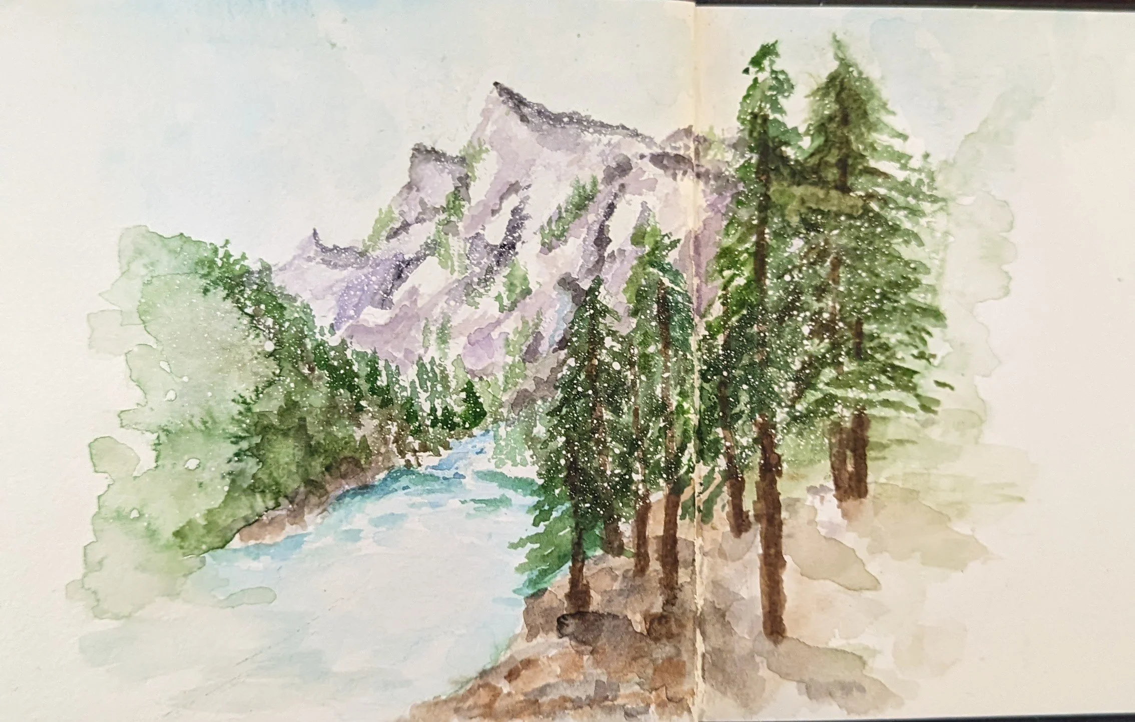 Watercolor painting of a mountain landscape with pine trees, a river, and mountains in the background.