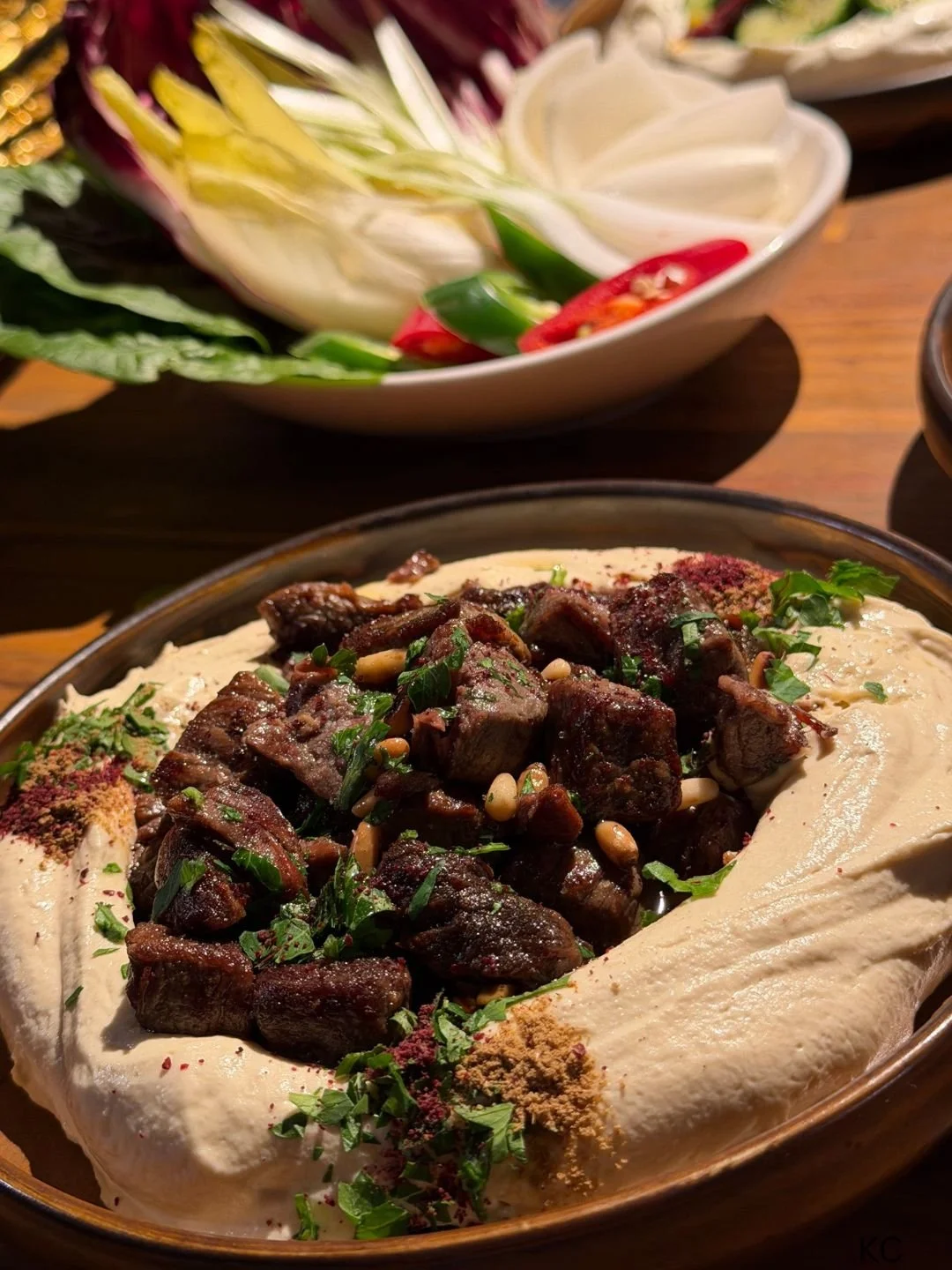 Hummus on a platter with meat and naan