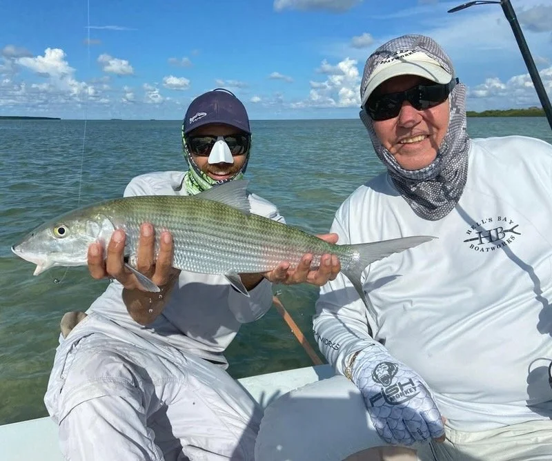Angler proudly holding a large Florida Keys bonefish while fly fishing the flats, showcasing one of the most sought-after inshore species. Bonefish are prized for their speed and strength, making them a top target in Islamorada, Biscayne Bay, and Eve
