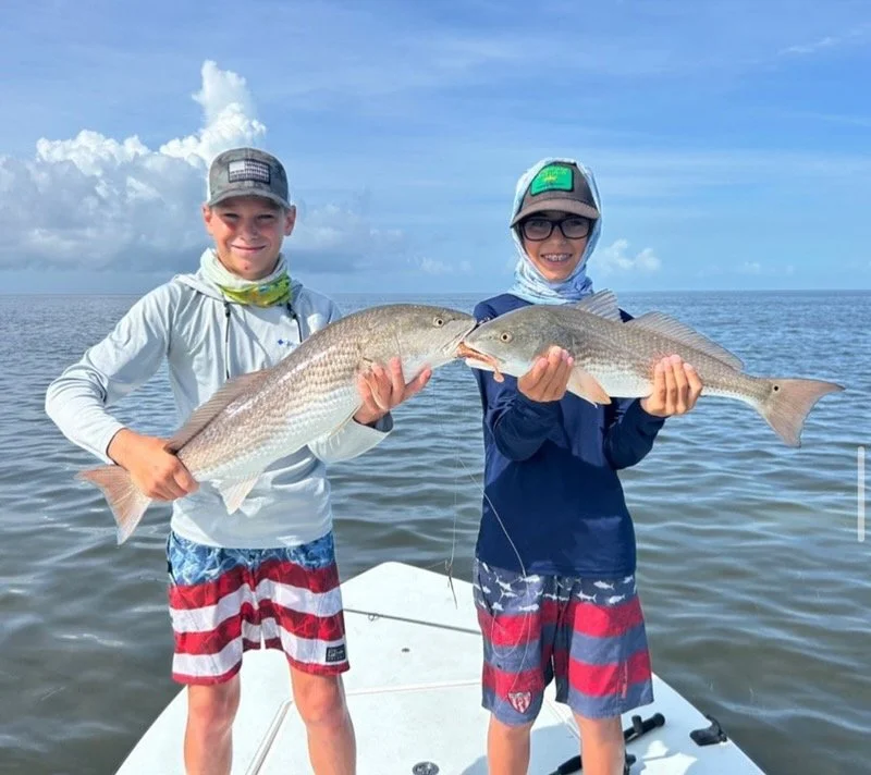 Double redfish caught in Islamorada, Florida Keys on a guided fishing charter. Perfect for kids, families, and anglers targeting redfish, snook, and tarpon.