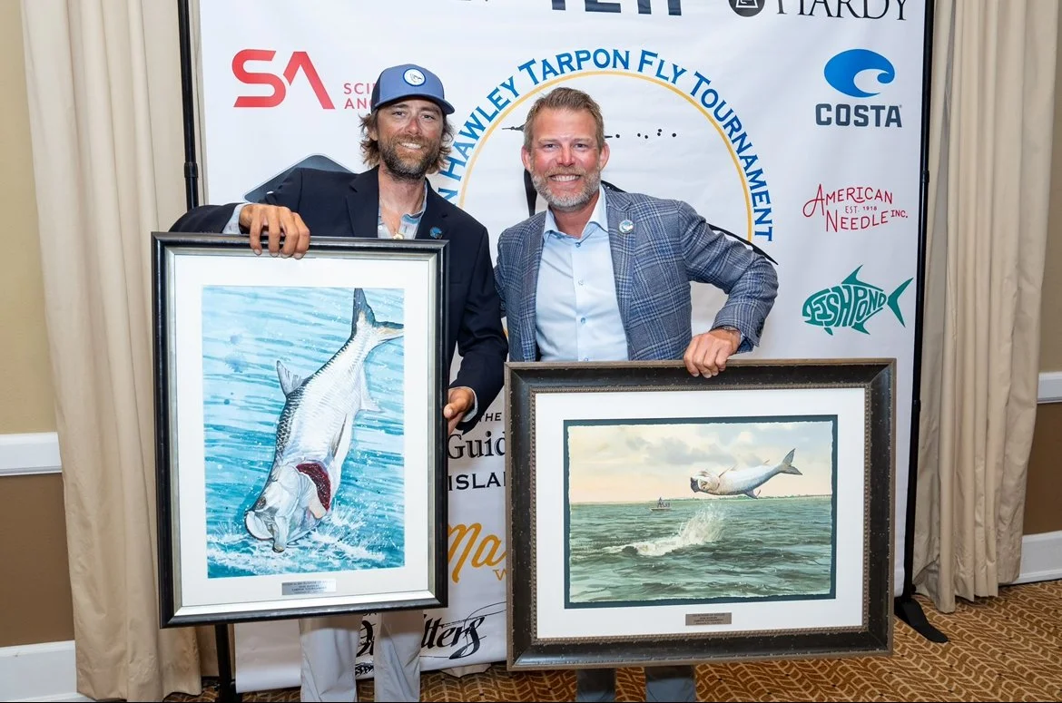 “Fishing tournament winners holding tarpon trophies at award ceremony in the Florida Keys.”