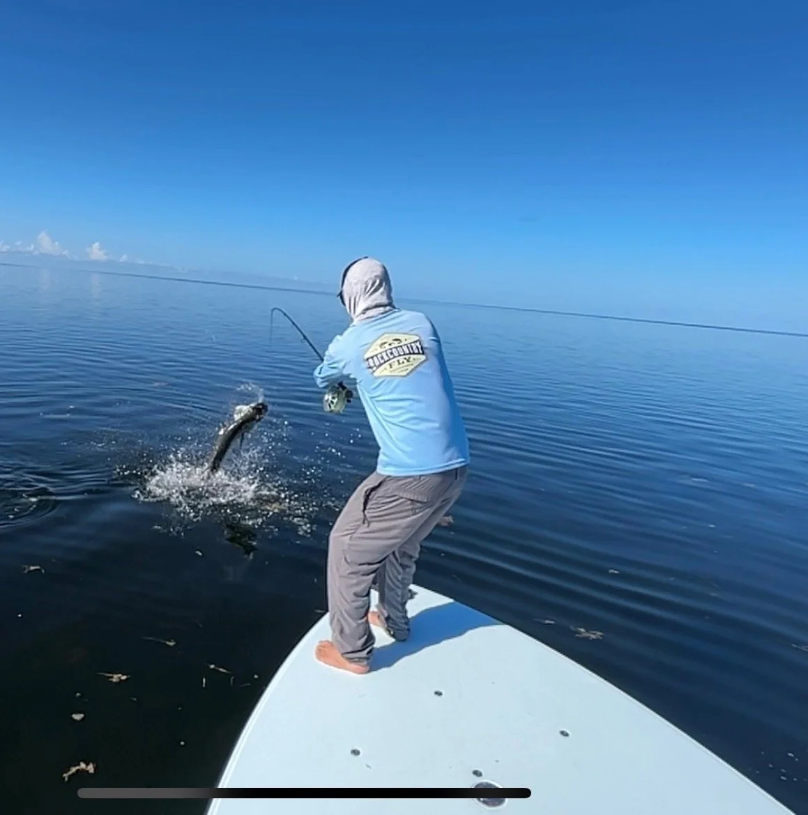 Fighting a powerful tarpon on fly from the bow of a Chittum Islamorada 18 skiff in the Florida Keys. This technical poling skiff offers unmatched stability and stealth, making it the perfect boat for targeting tarpon, bonefish, and permit on the flat