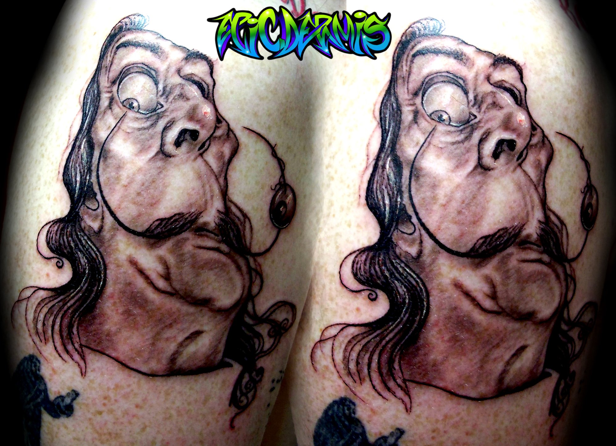 Salvador Dali black and grey caricature tattoo on upper arm done by Colin Nolt at Epicdermis Tattoo Studio in Lancaster PA
