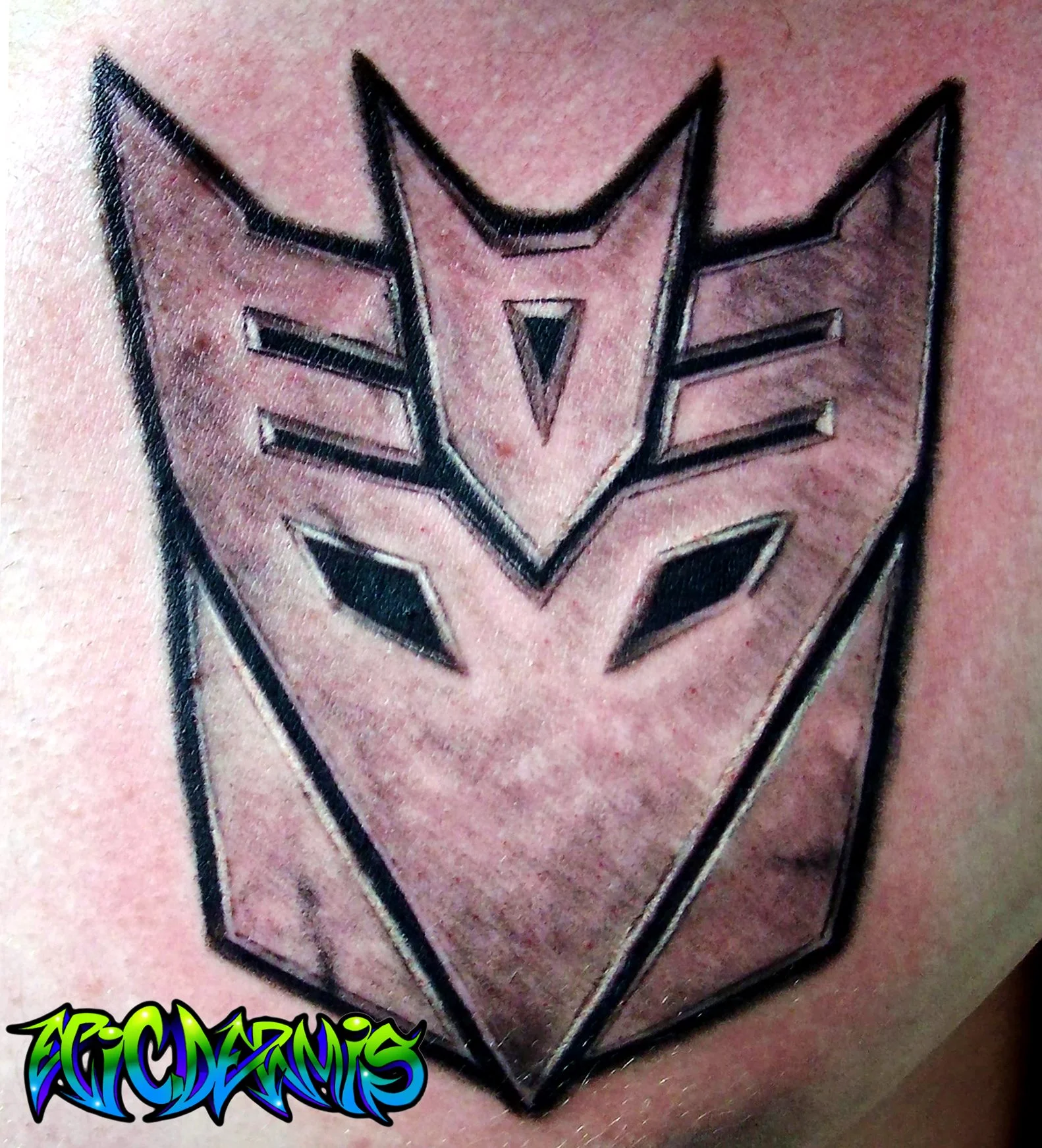 Transformers Decepticon Emblem tattoo done in black and grey on chest by Colin Nolt at Epicdermis Studios in Lancaster PA