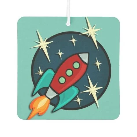 A colorful space-themed tag featuring a cartoon rocket ship with blue wings and a red body, flying through space past stars and planets.