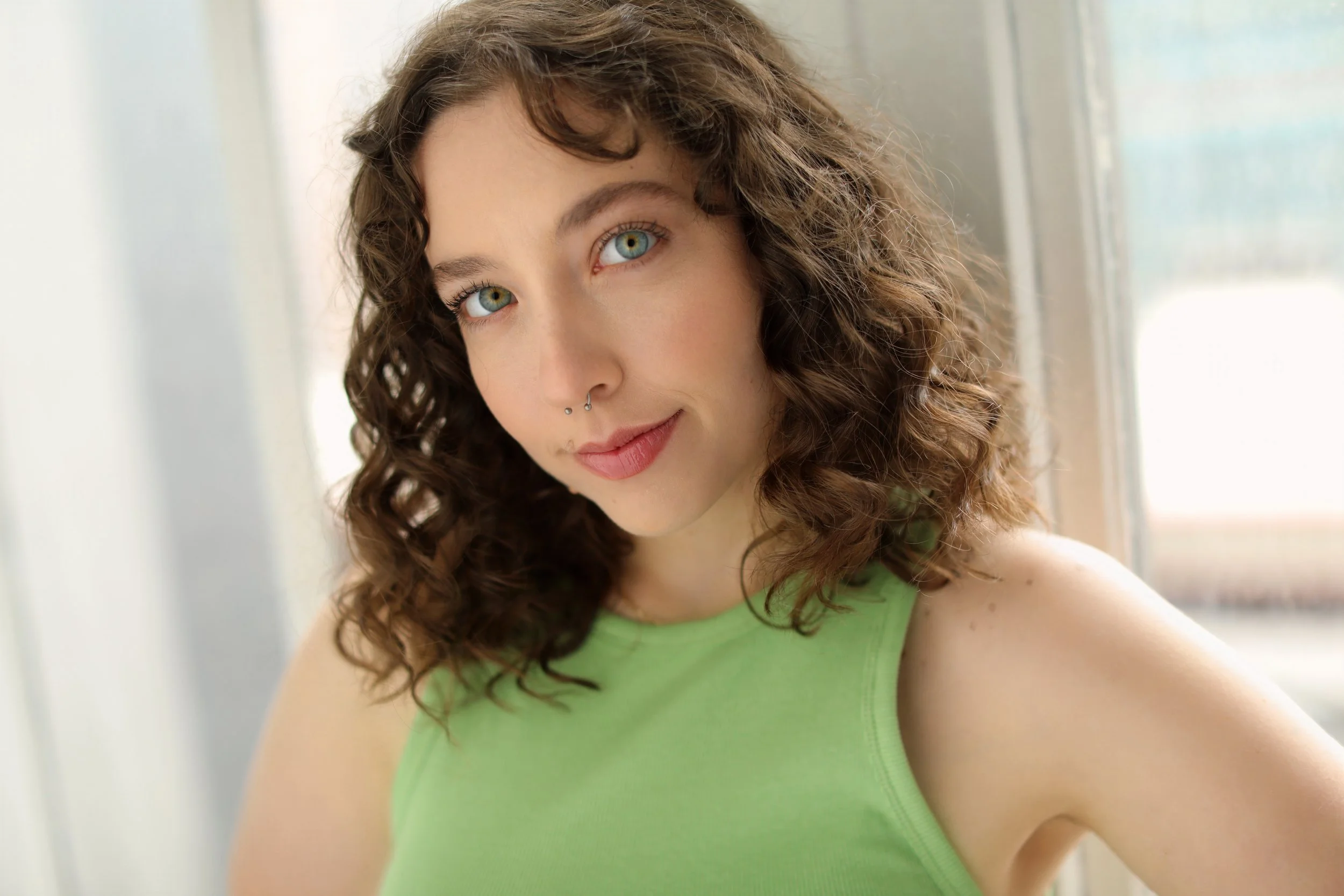 A woman with green eyes and a green shirt