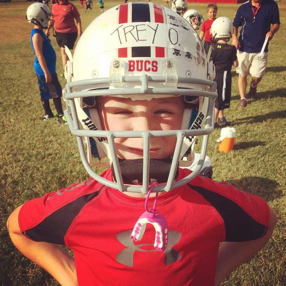 Trey Owens wearing a football helmet.