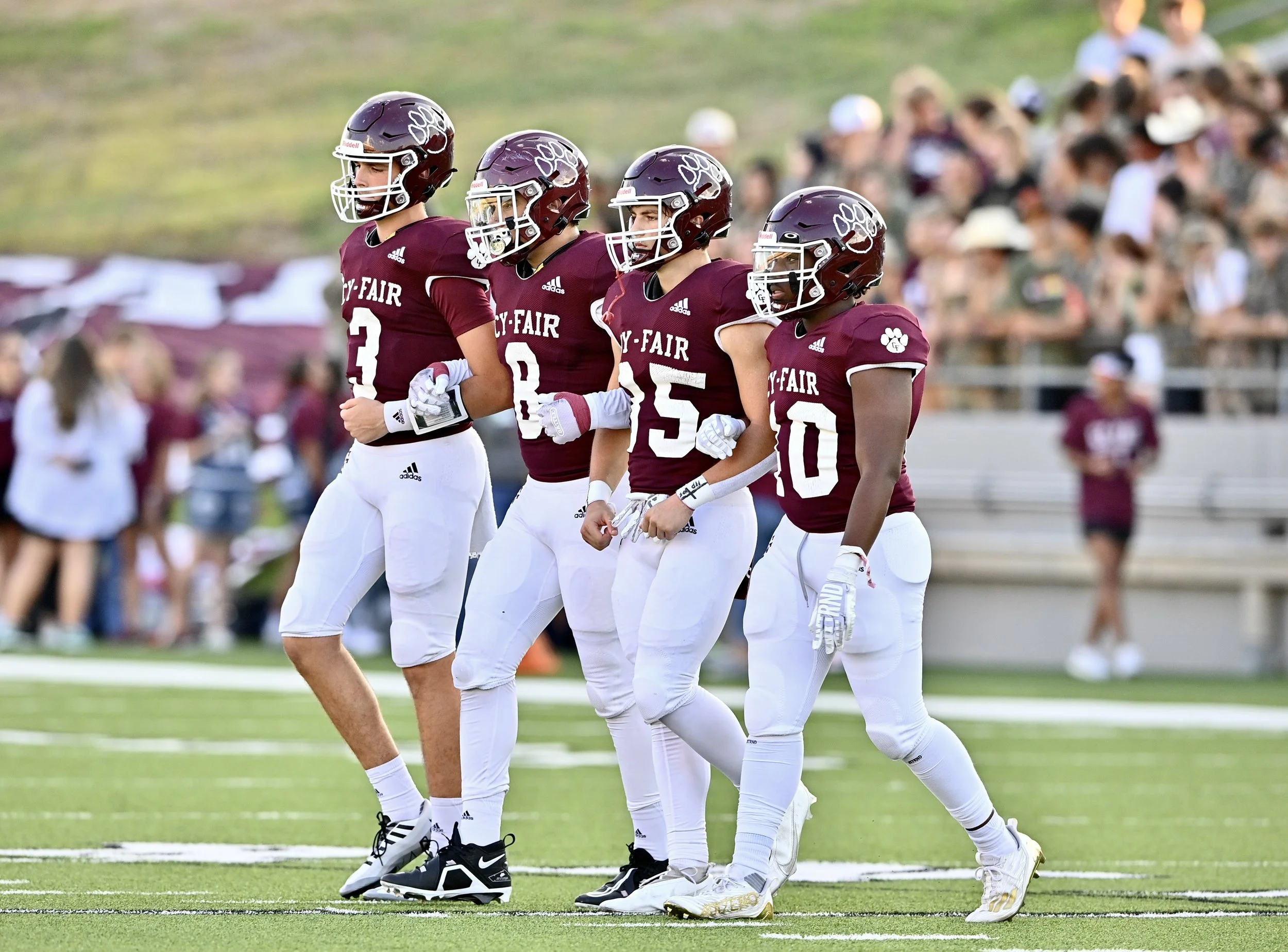 Cy-Fair captains walking onto the field.