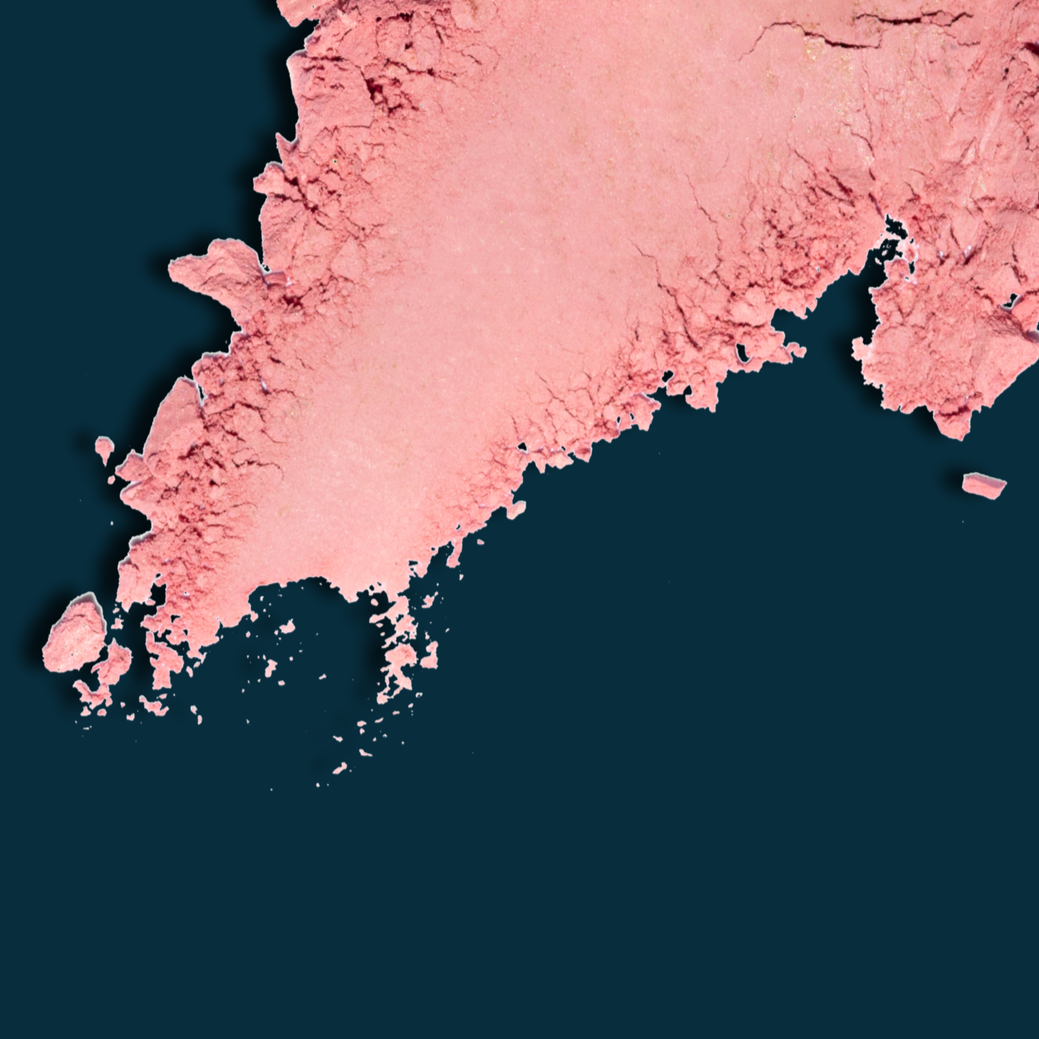 Spilled pink powder on a dark background.