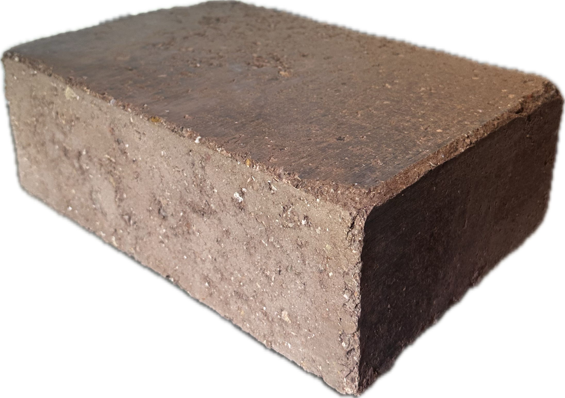 A close-up view of a rectangular stabilized compressed earth block with a rough, textured surface and a reddish-brown color.