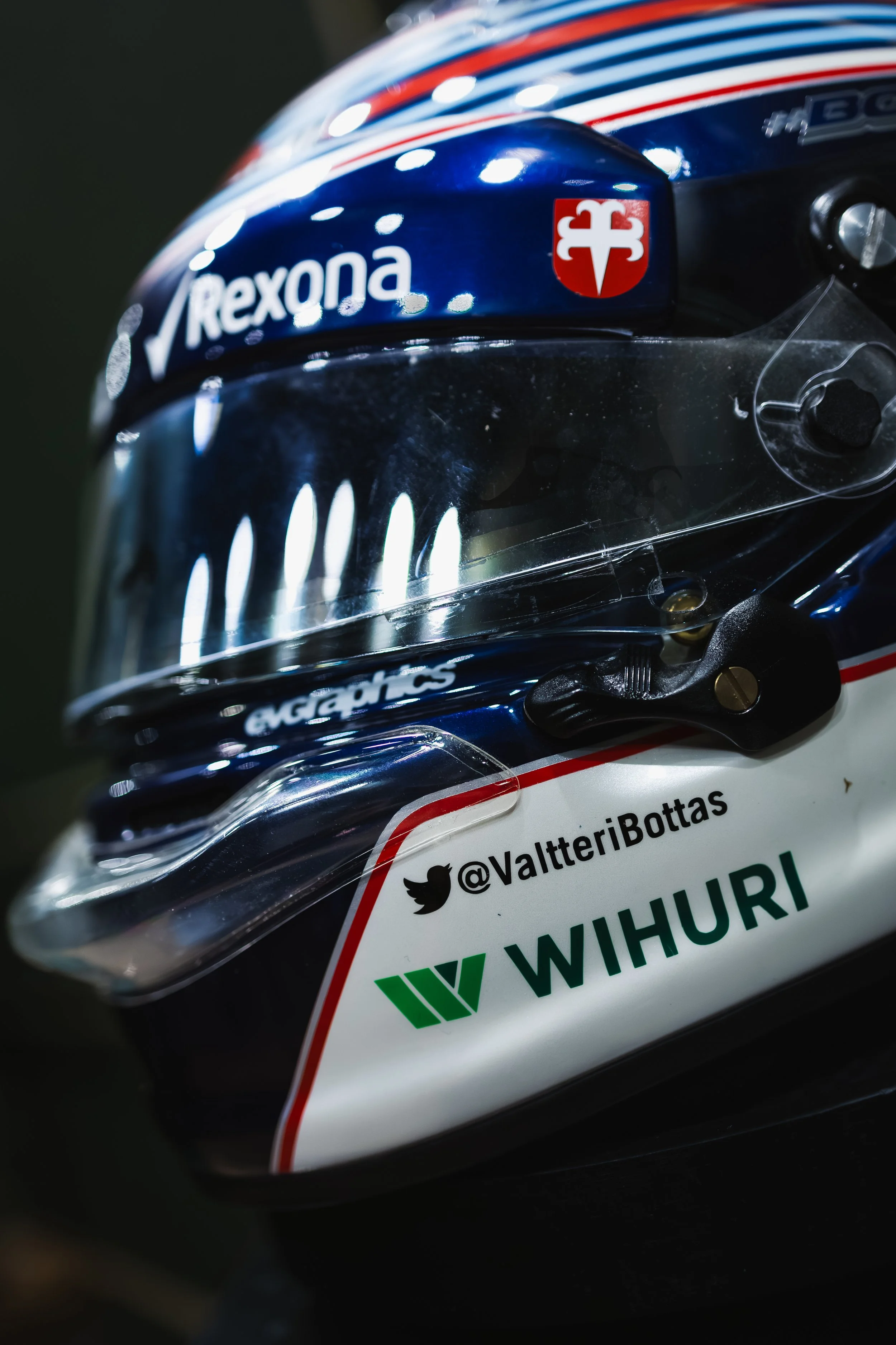 Close-up of a racing helmet with sponsor logos, including Rexona, WIHURI, and a Twitter handle @ValteriBottas.
