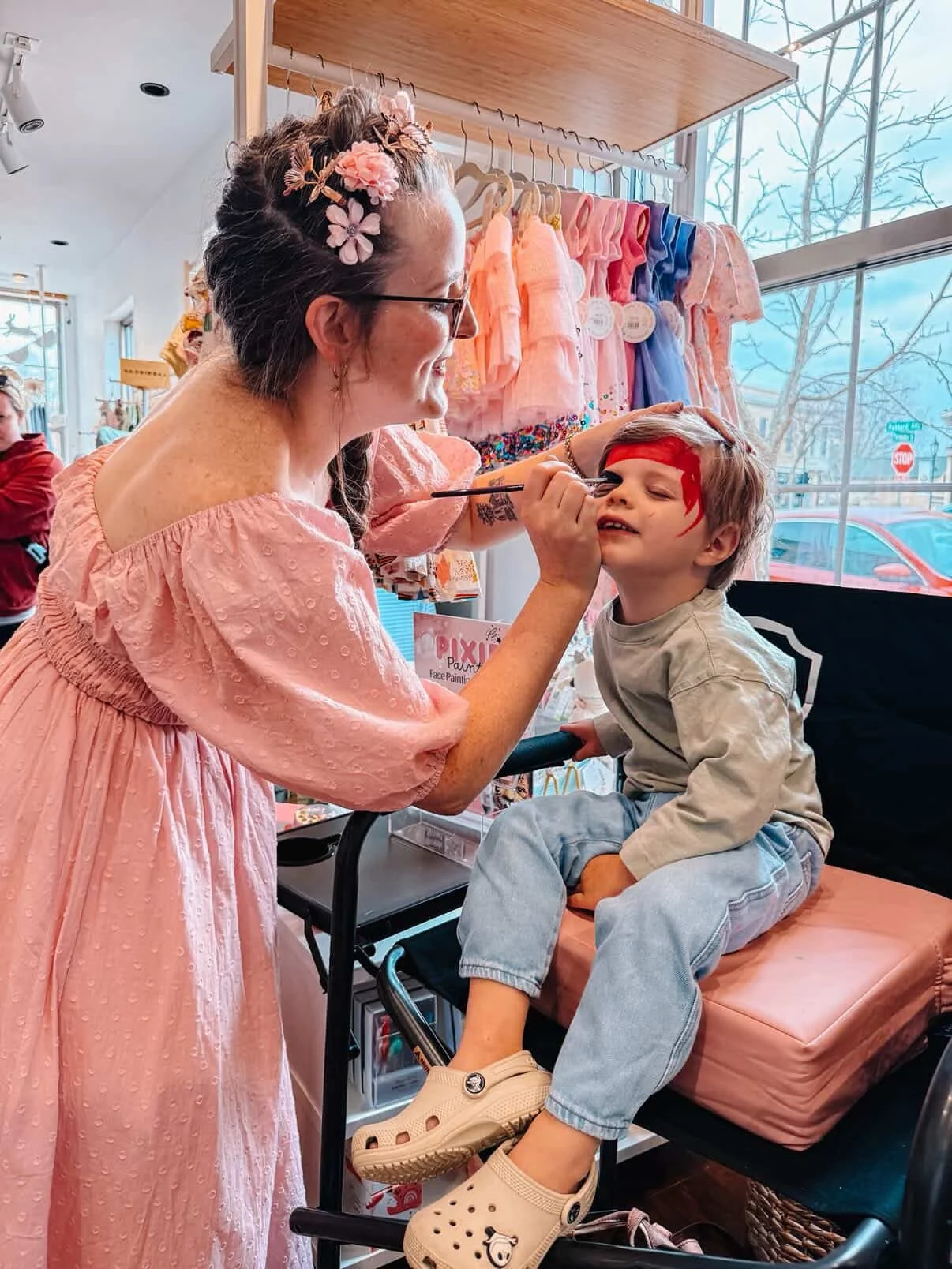 Pixie Paints face painting child in chair in Middleton, WI