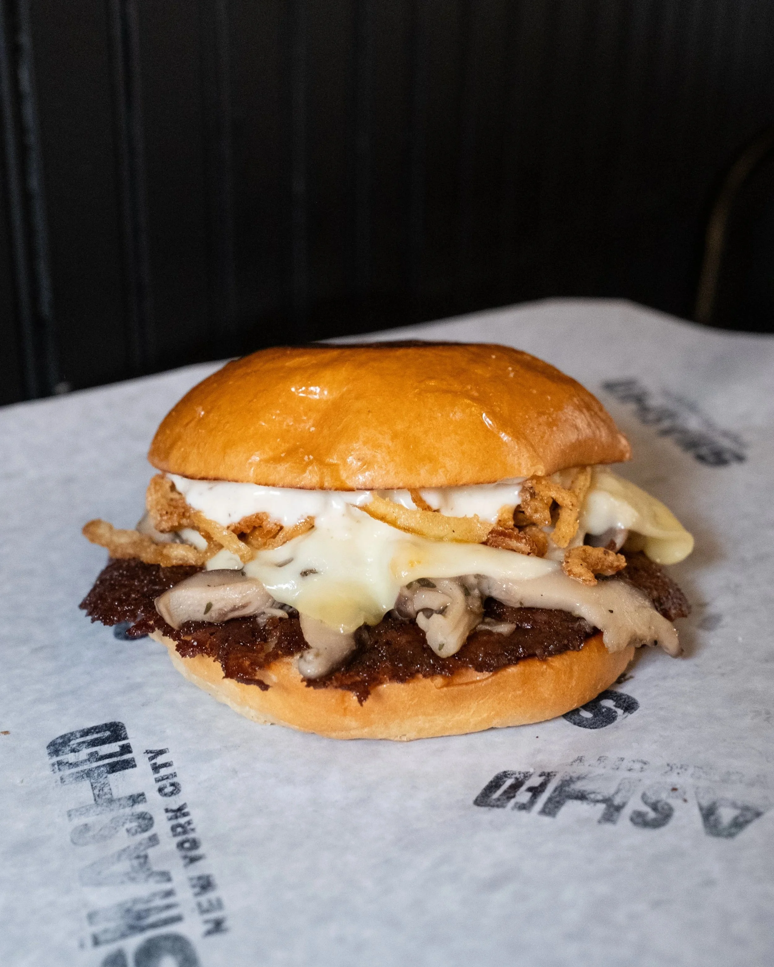 Smashed mushroom burger with swiss gruyere cheese and fried onions at union square