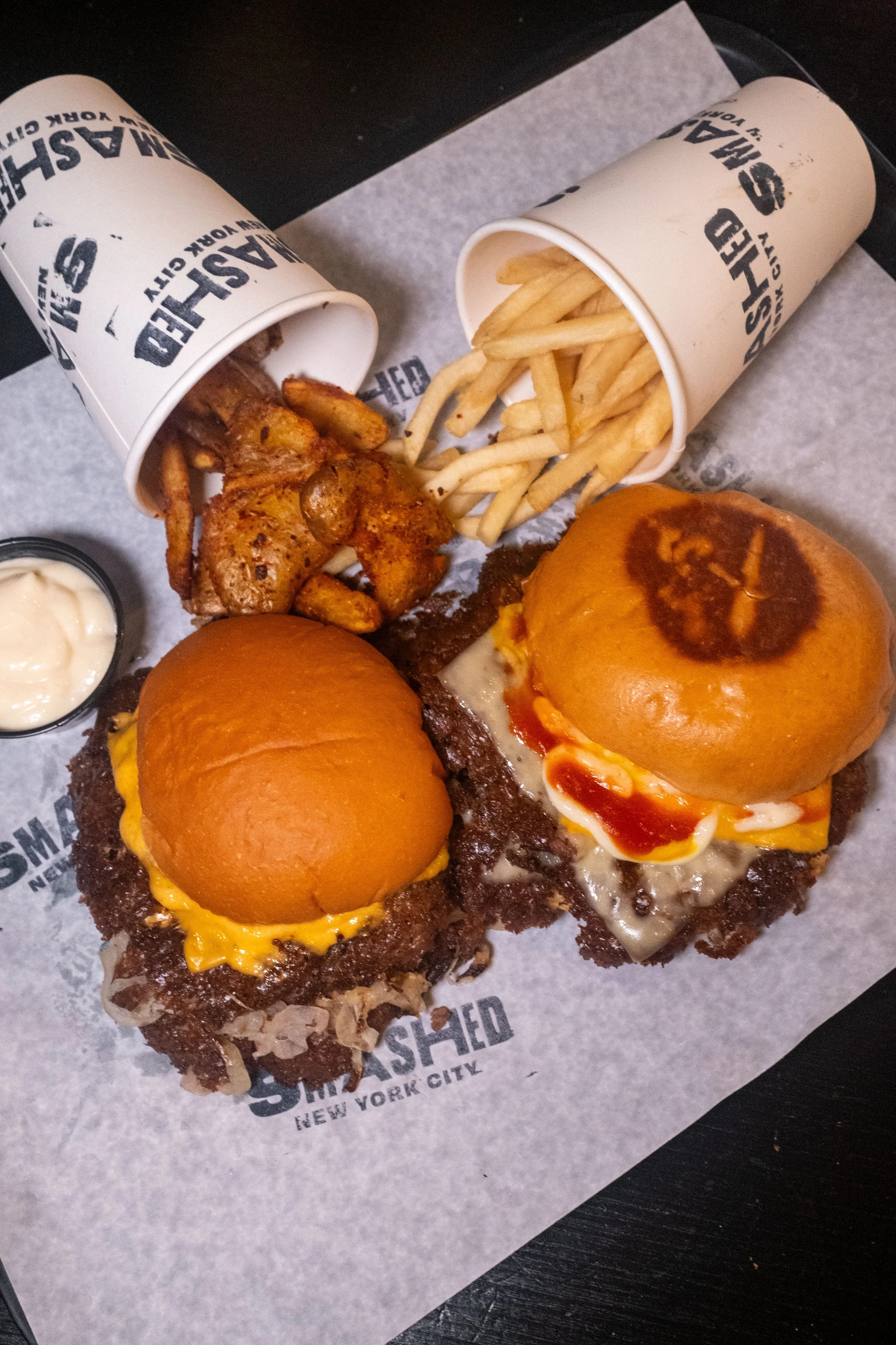 Ultimate cheeseburger and oklahoma burger with smashed potatoes and fries