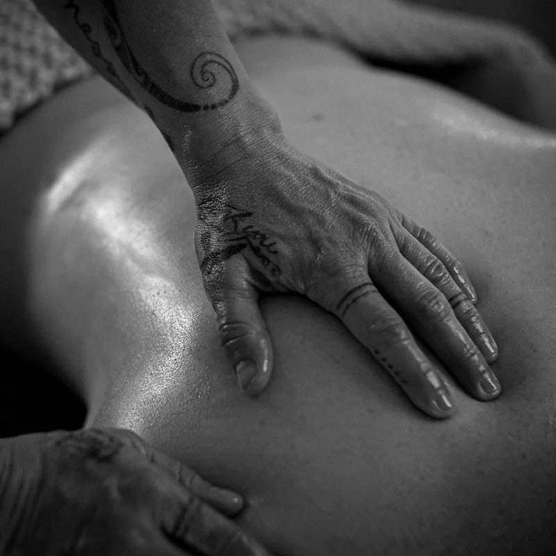 Hands massaging a persons back